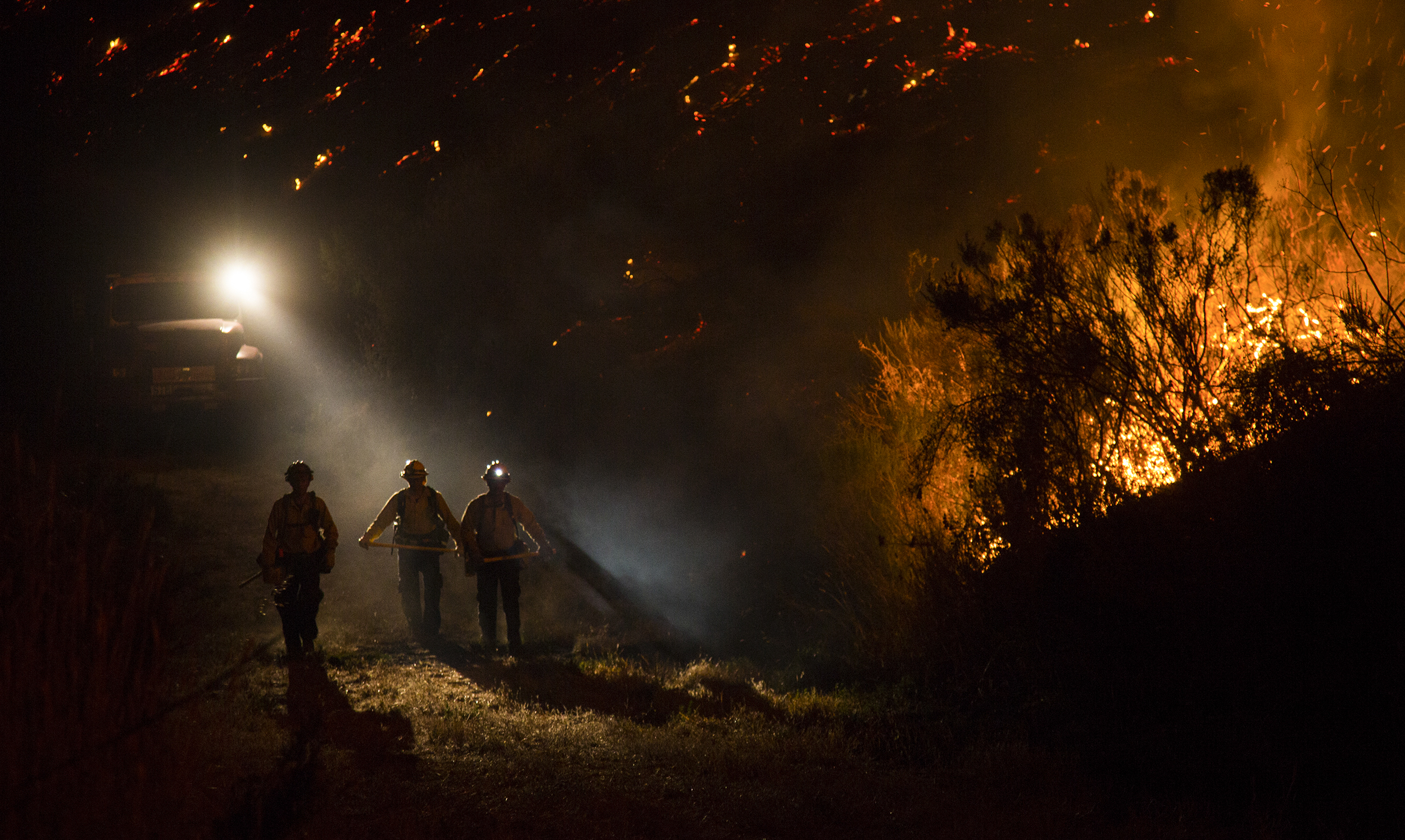  Firefighters fight the Refugio Fire along a trail behind the El Capitan Canyon camp in Santa Barbara, CA. Firefighters continue to fight more aggressive wildfires as the drought continues in California for its fifth year.&nbsp; 
