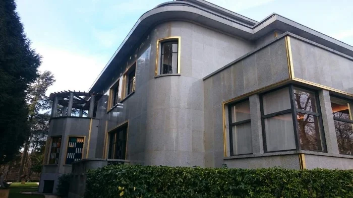 Gold leaf framed windows and polished granite add bling to Brussels quiet suburbia.