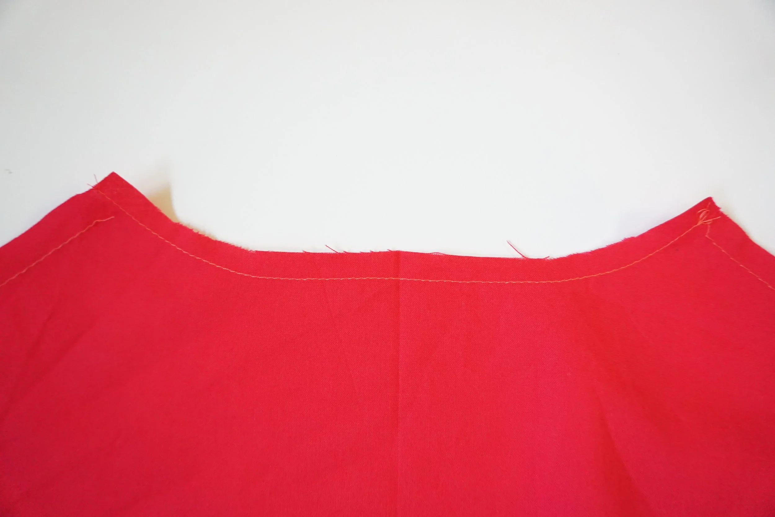 Step 6: STAYSTITCH the neckline of the back bodice. Stay-stitching prevents the garment from stretching out while we are constructing it. STAYSTITCH : stitch 1/2" from raw edge. This stitch should be in the seam allowance.