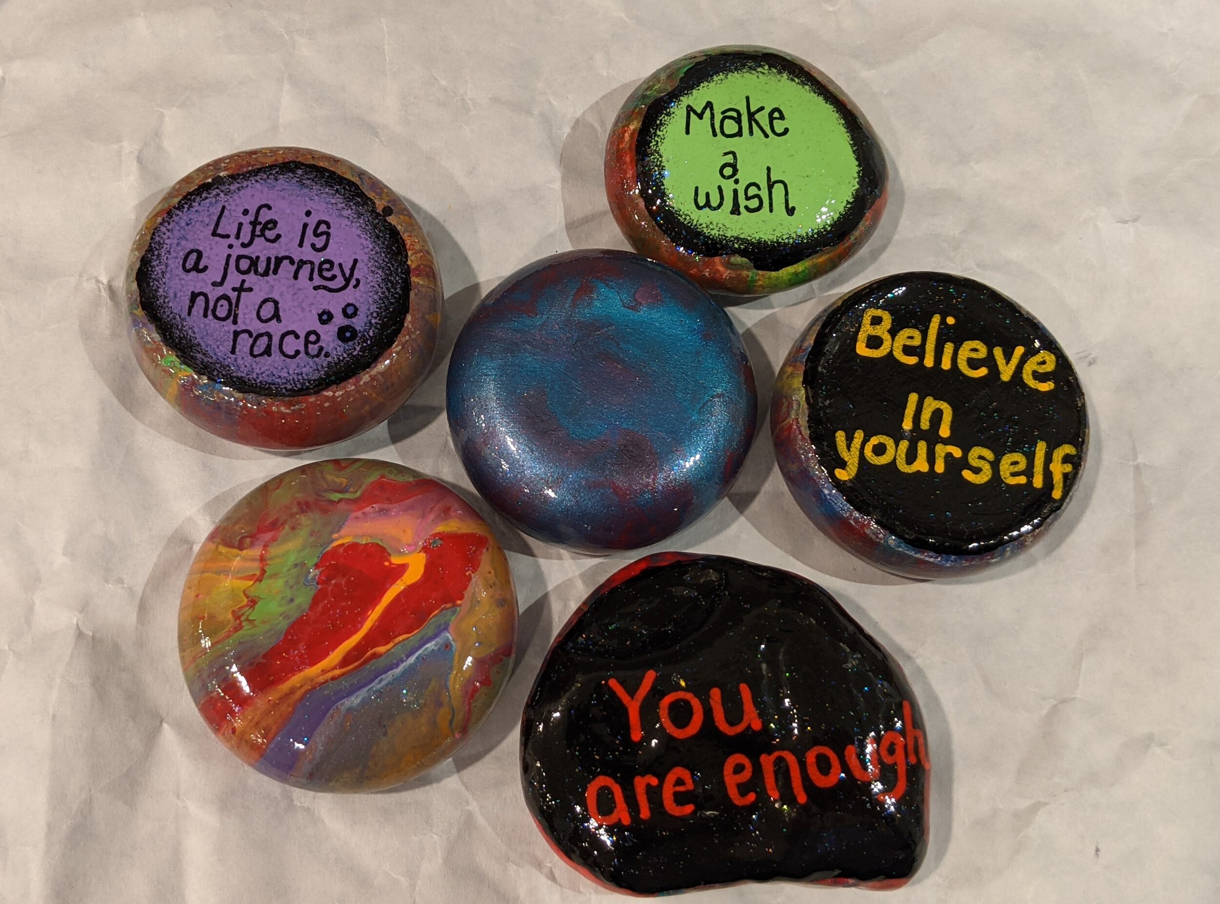 painted rocks with inspiration words.jpg