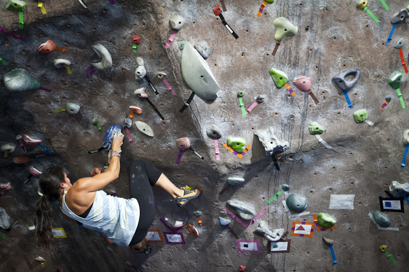 Woman bouldering at indoor climbing gym in Portland, Maine | Photo by Whitney J. Fox Photography