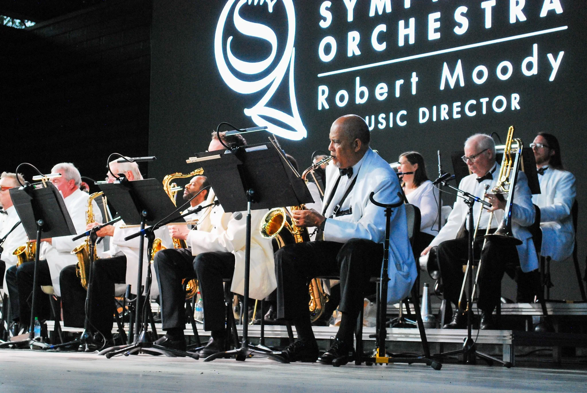 Six gentleman playing brass instruments on the stage in The Grove