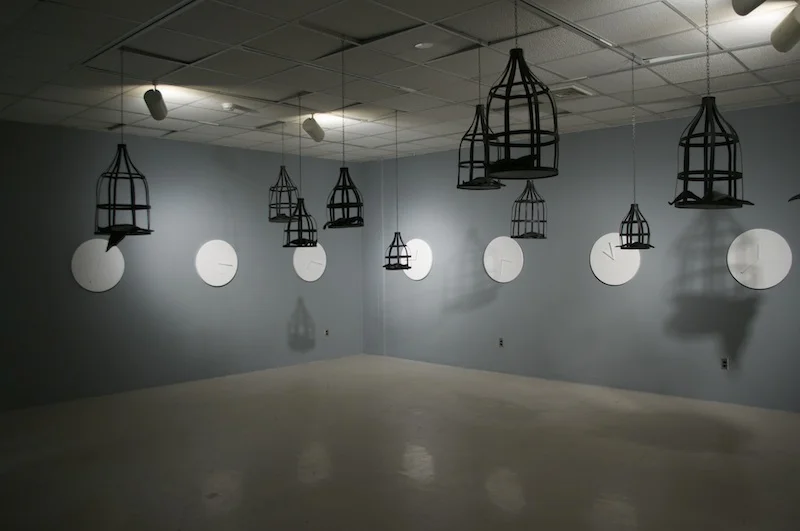  A site specific installation at Stony Brook University's Lawrence Alloway Gallery. &nbsp;  12 Bird Cages constructed of wood  12 Birds constructed of papier-mache  11 Clocks constructed of chipboard and clock parts.  2015 