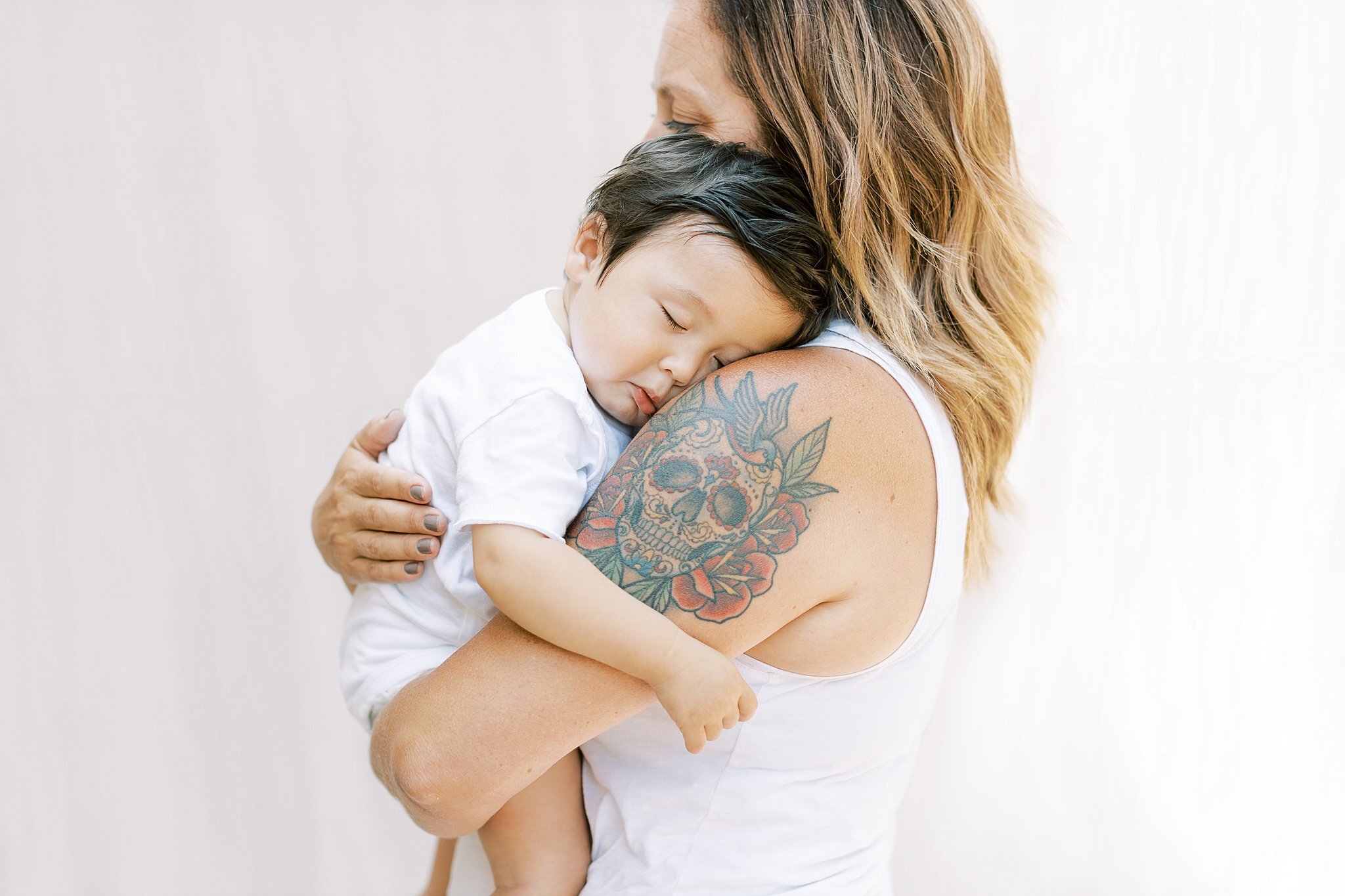 tattooed-mom-holding-sleeping-baby.jpg