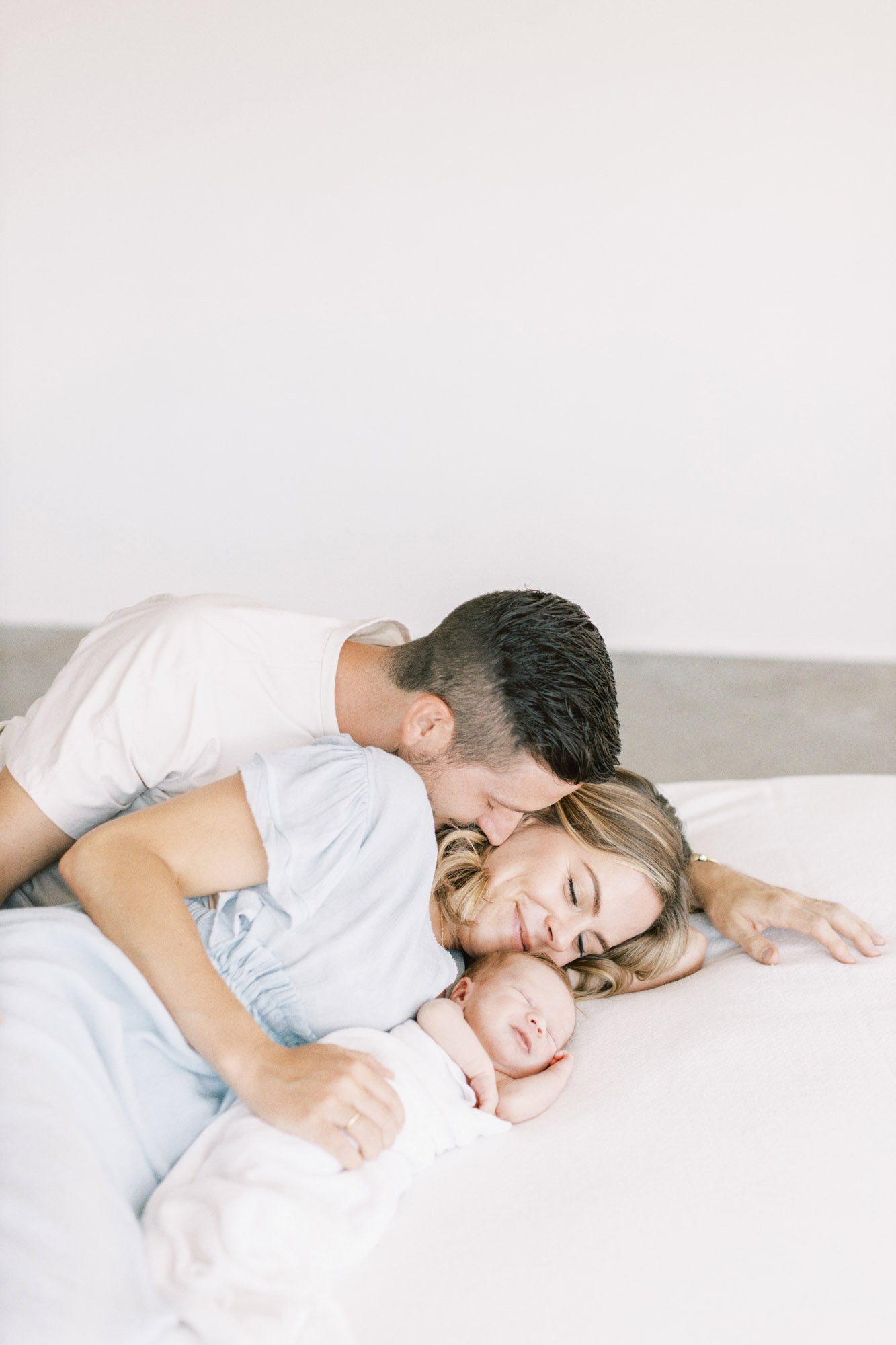 family-with-newborn-on-bed.jpg