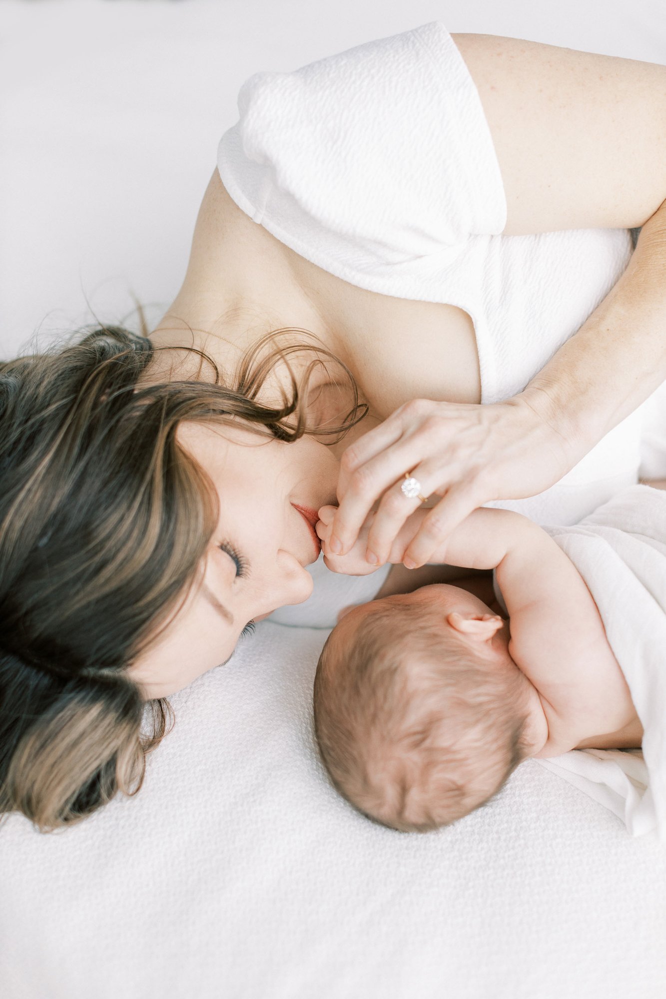 mom-kissing-newborn-hand.jpg