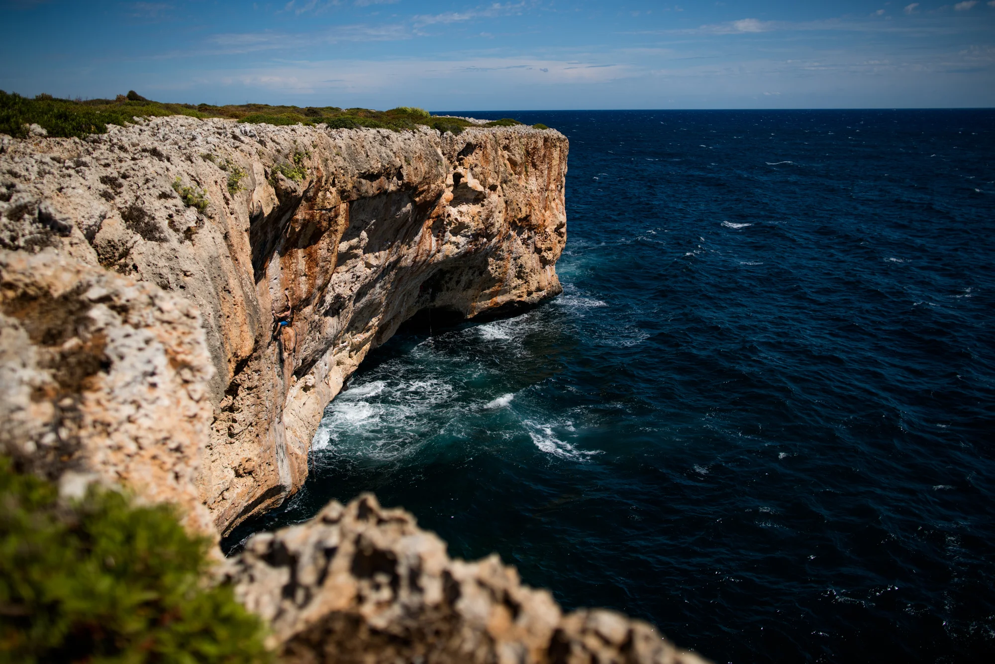 Wide view of The Diablo Wall. Greg climbing through the juggy pockets on Surfer Dead on the left side of the cave. 