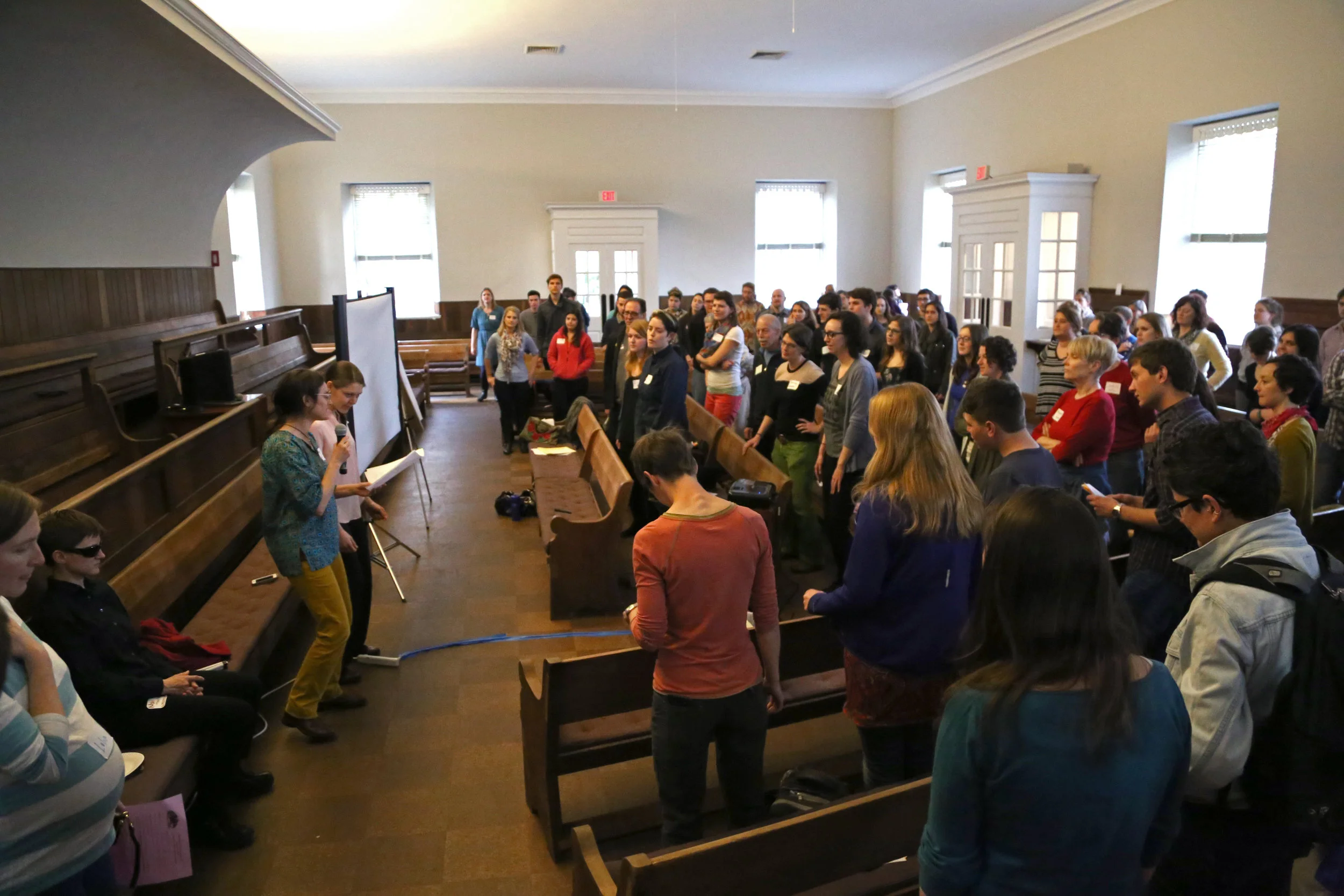 SURJ DC a crowd of people, most of them white, stand in rows of pews..jpg