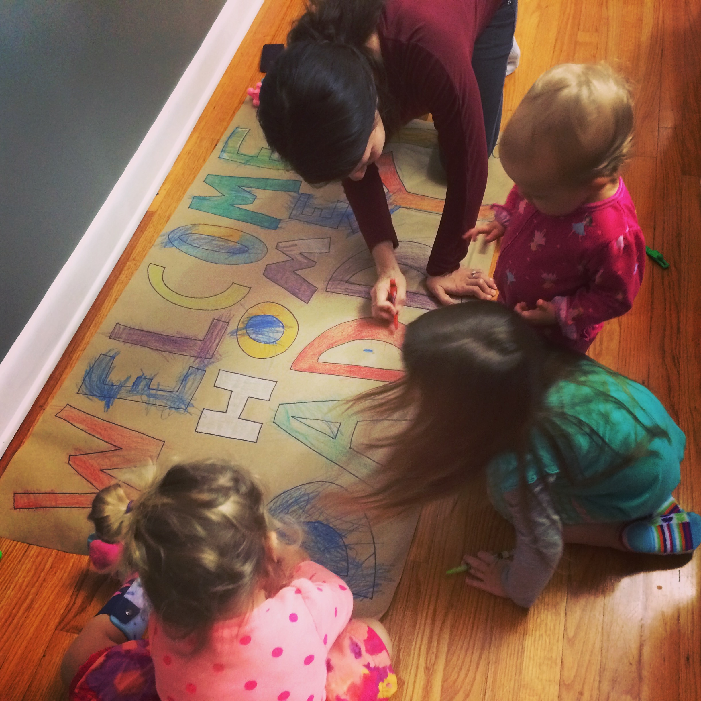 My girls with their Auntie preparing a sign for daddy, morning of his return.