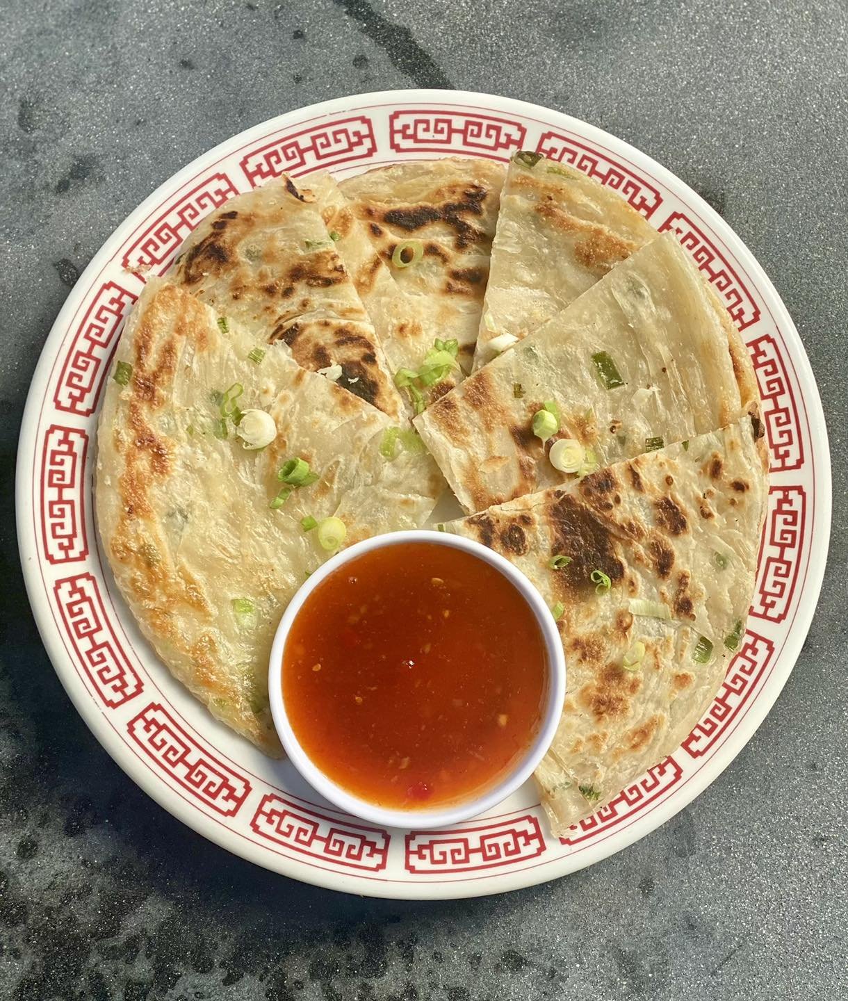 Introducing a May feature, Scallion Pancakes!

Savory, unleavened flatbread folded with oil and minced scallion. Served w/ chili plum sauce 😋🤌