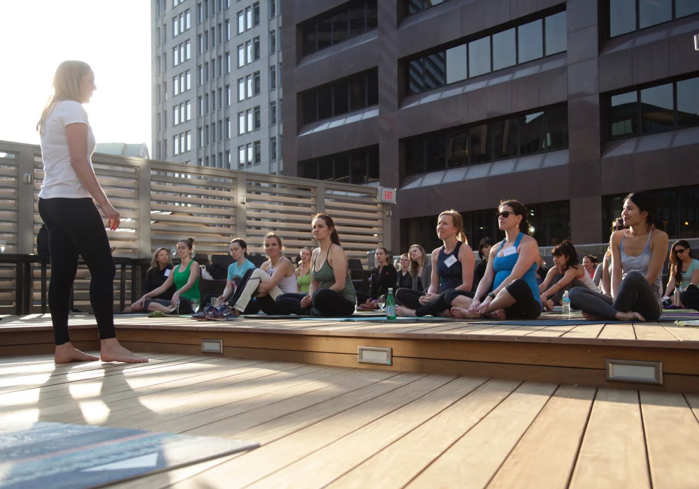Anusia Gillespie leads lawyers and HR professionals through vinyasa flow at Vino & Vinyasa