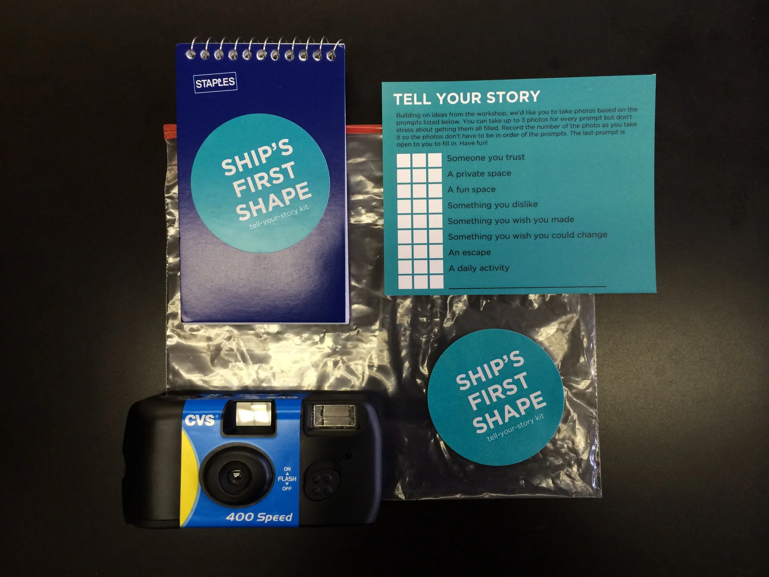  Tell-Your-Story kit comes in a clear plastic bag with a Ship’s First Shape sticker. In it, there is a disposable camera, a prompt card, and a notepad. The prompt encourages users to building on ideas from the workshop by taking up to 3 photos for to