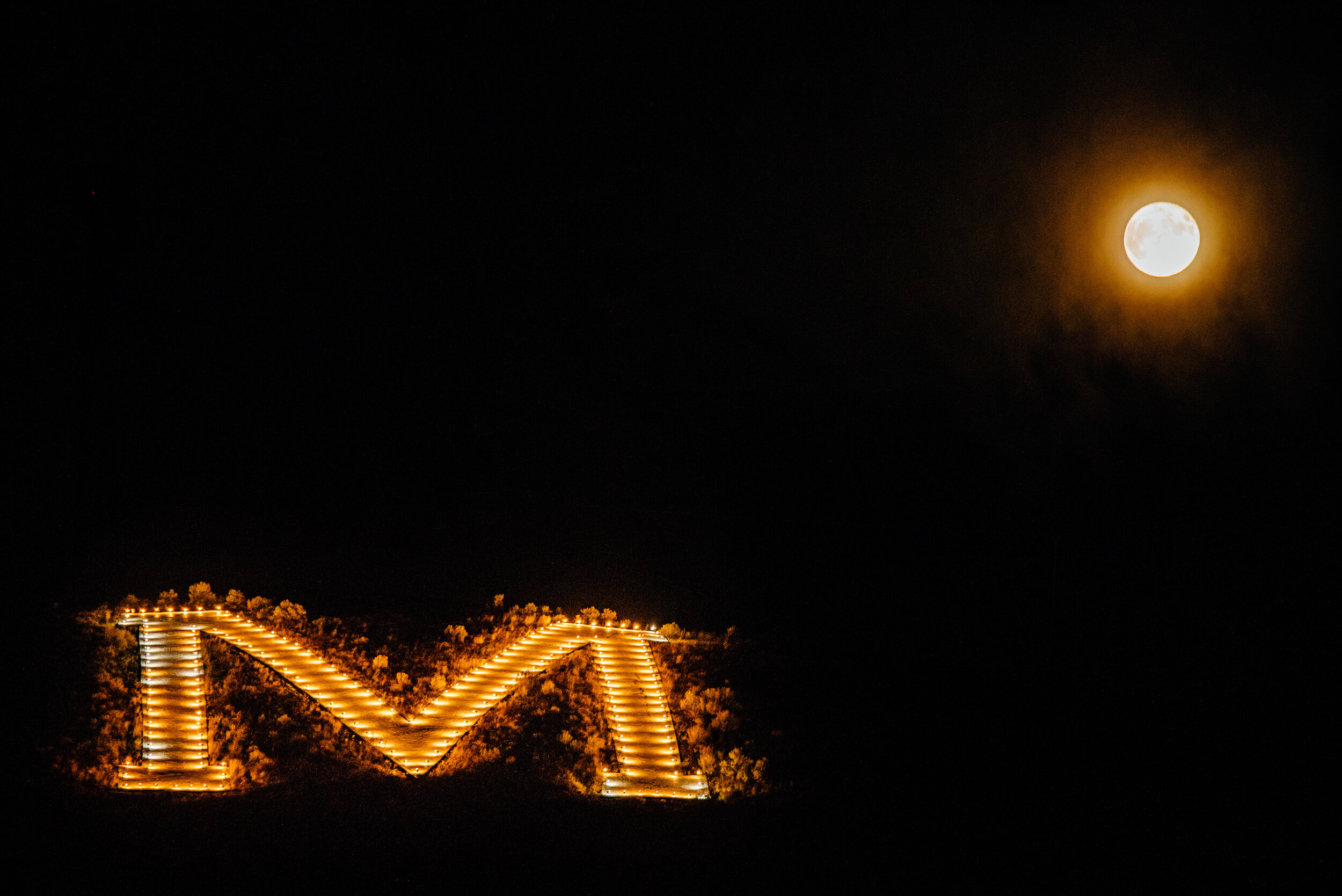 In the tiny town of Monteplier, ID, I discovered the largest &amp; most illuminated letter on a hill behind the town I'd seen in my whole life. And even caught the full moon!