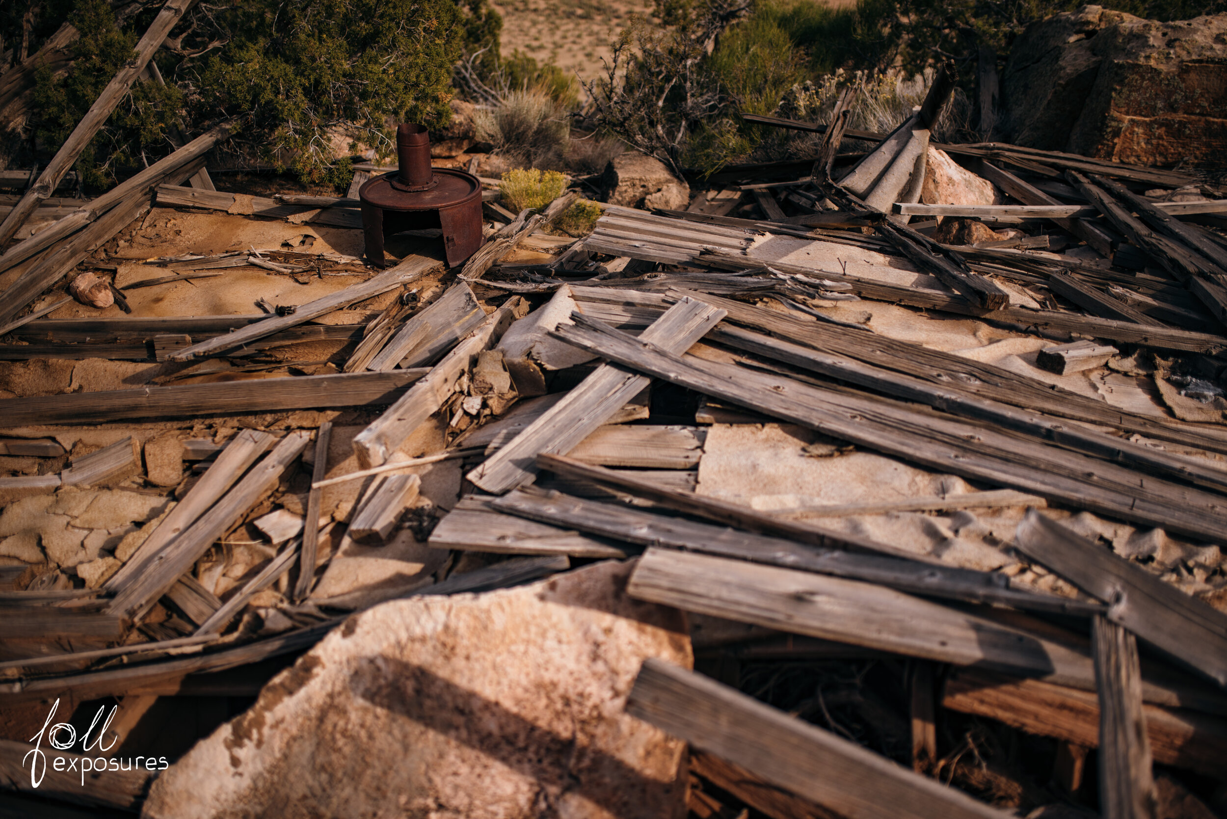  What’s left of a structure plus a homemade stove on the left. 