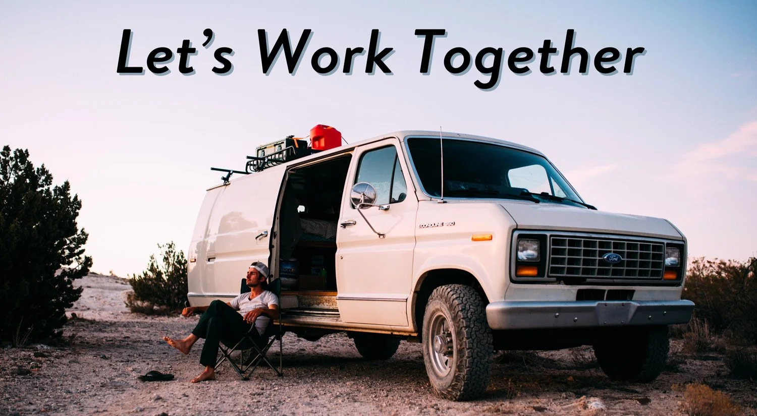 A man sit in front of his van while living the vanlifer lifestyle.