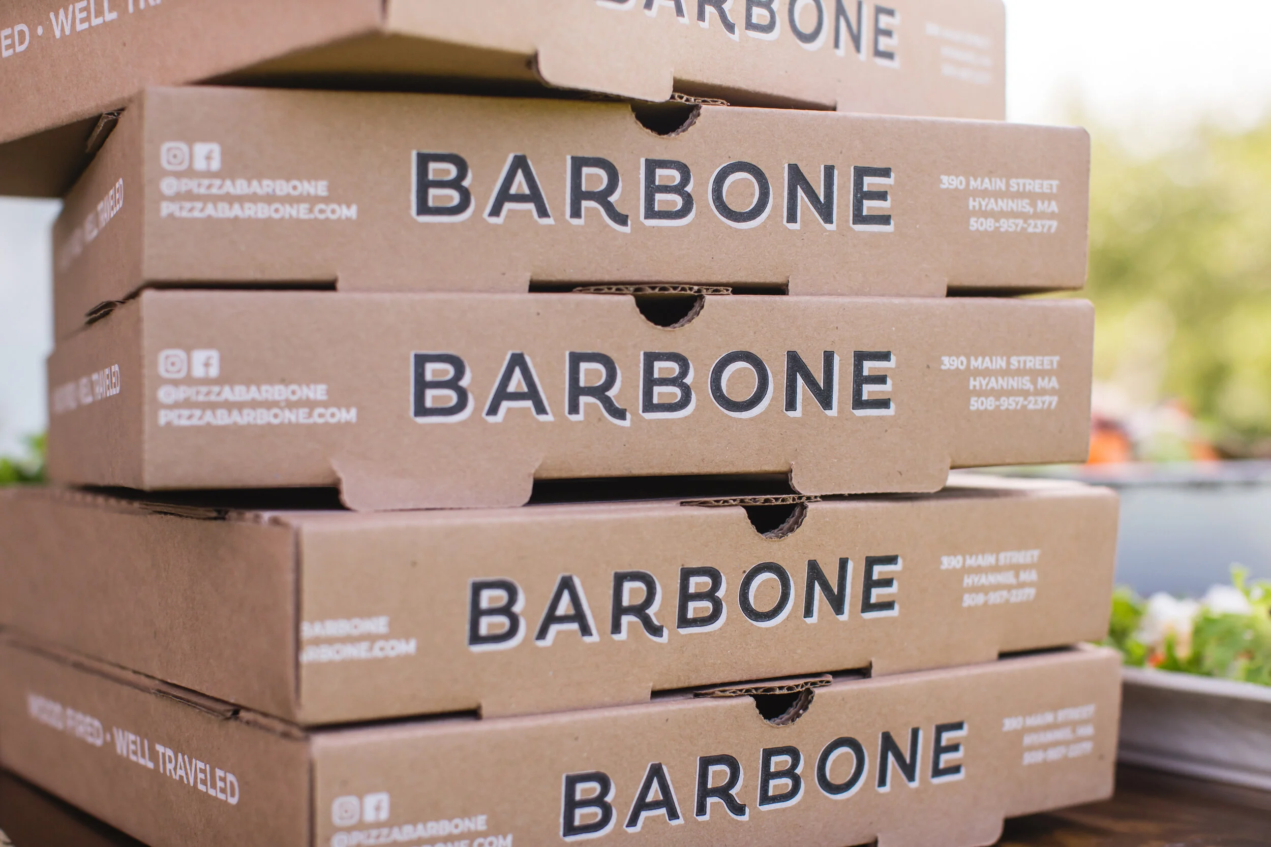 Stack of Pizza Barbone branded takeout pizza boxes at 390 Main Street, Hyannis