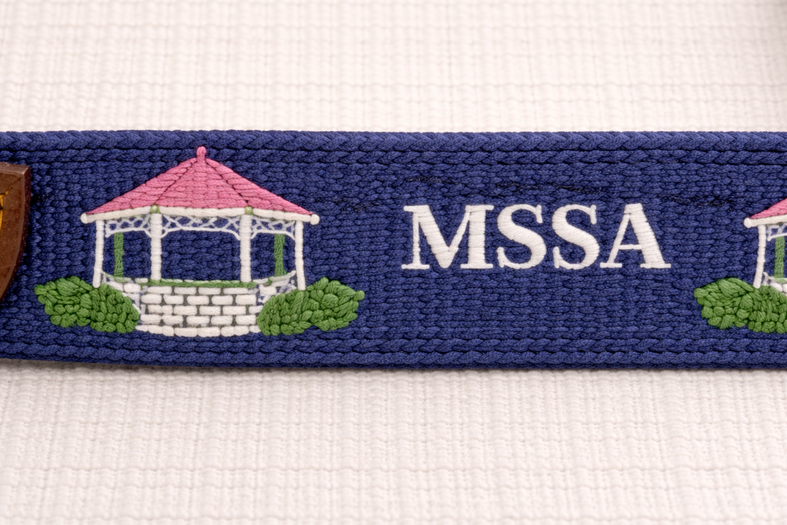 Intricate needlepoint on navy strap.png