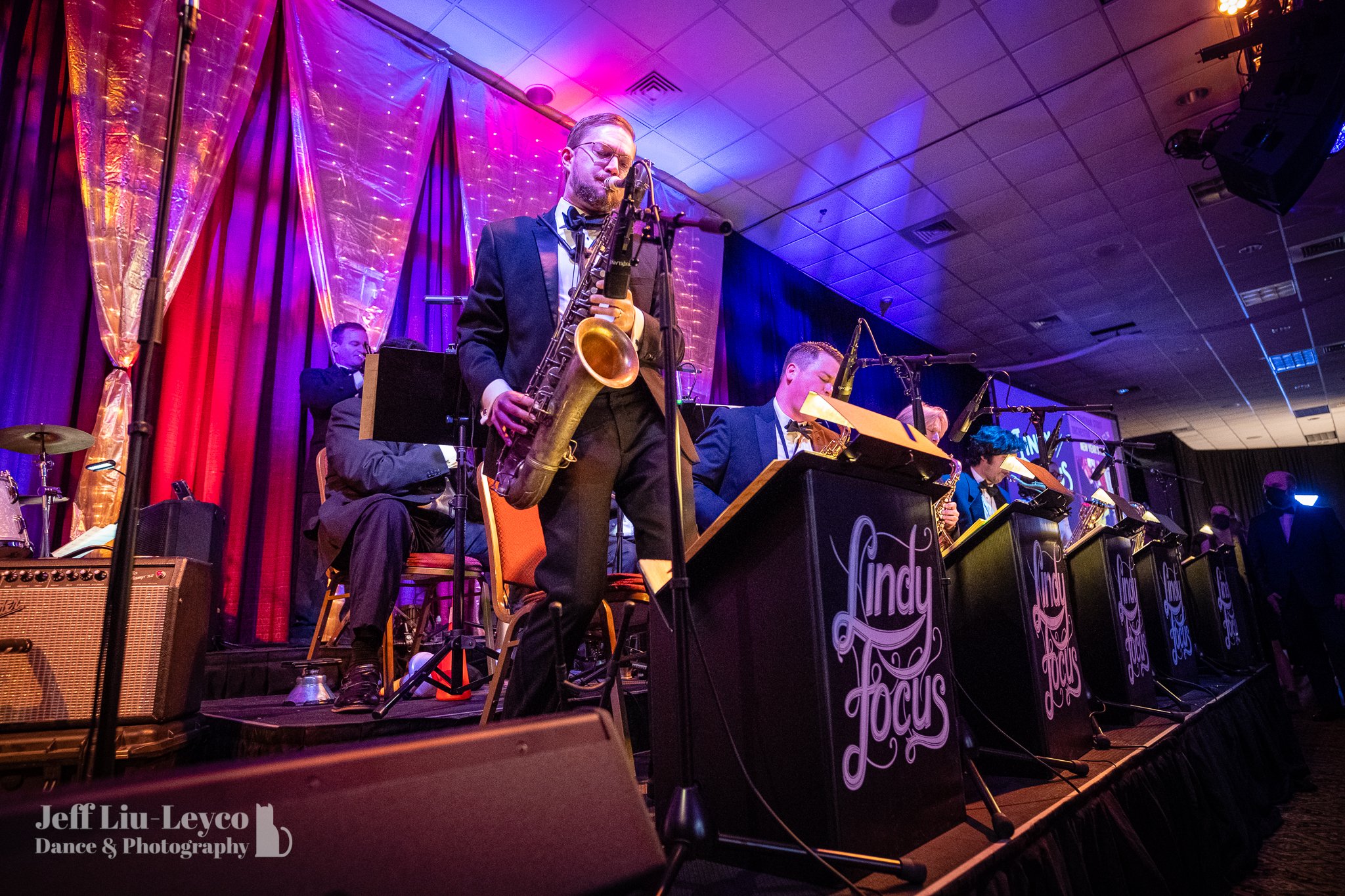  Keenan plays a saxophone solo, standing up on the stage in Expo. 