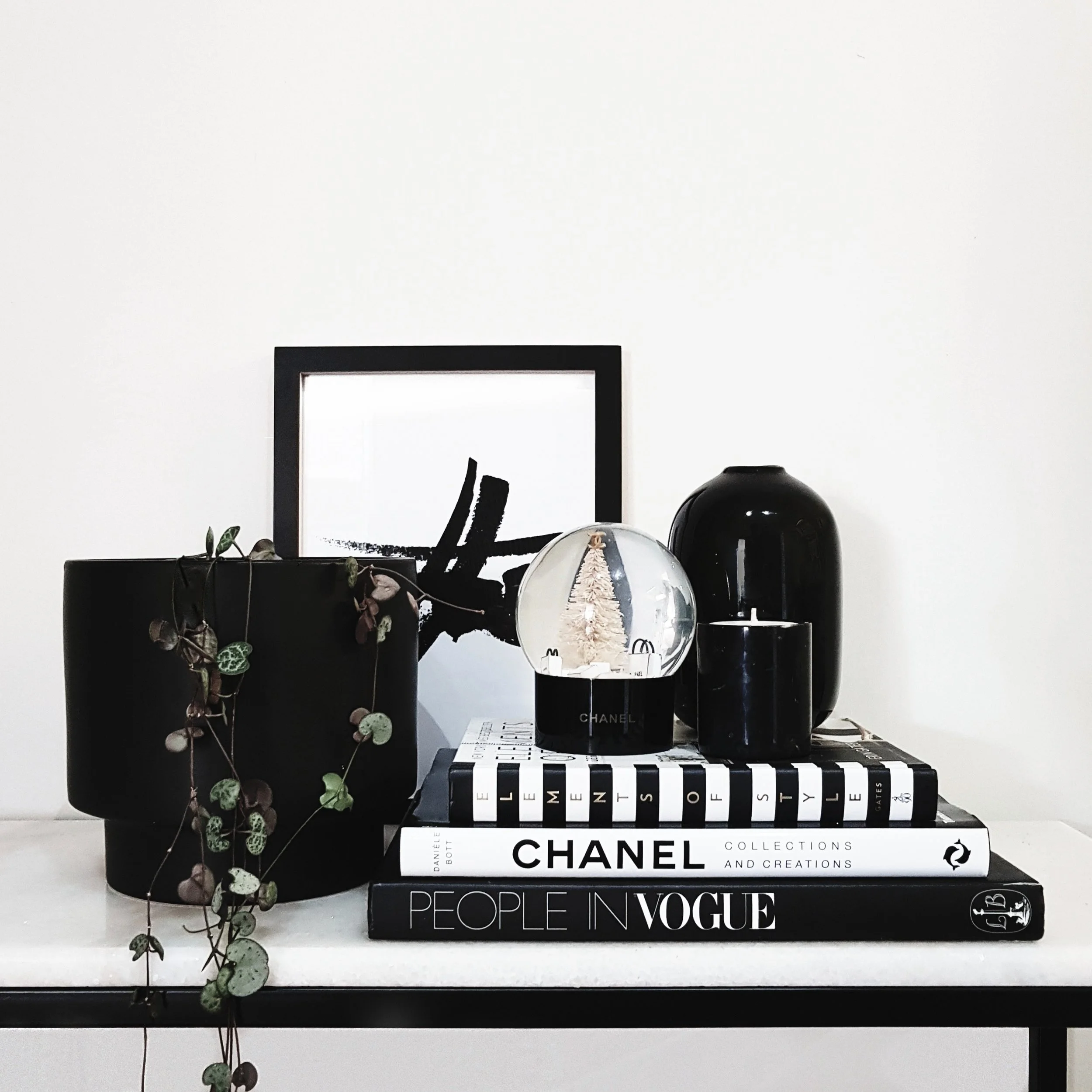 Try adding a framed print or photo to your vignette.