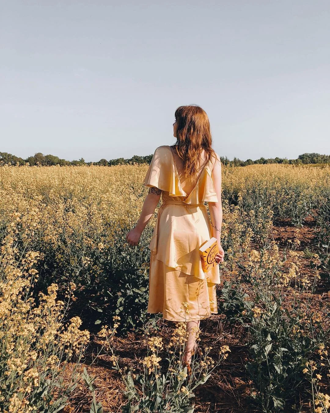 Bronte amongst the flowers dressed in a complementary dress and book in hand. Source: @frombeewithlove