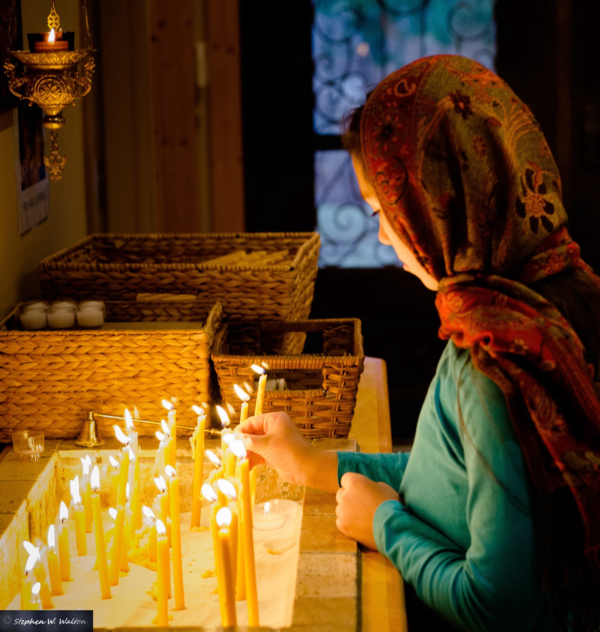 young girl in front of the candle stand