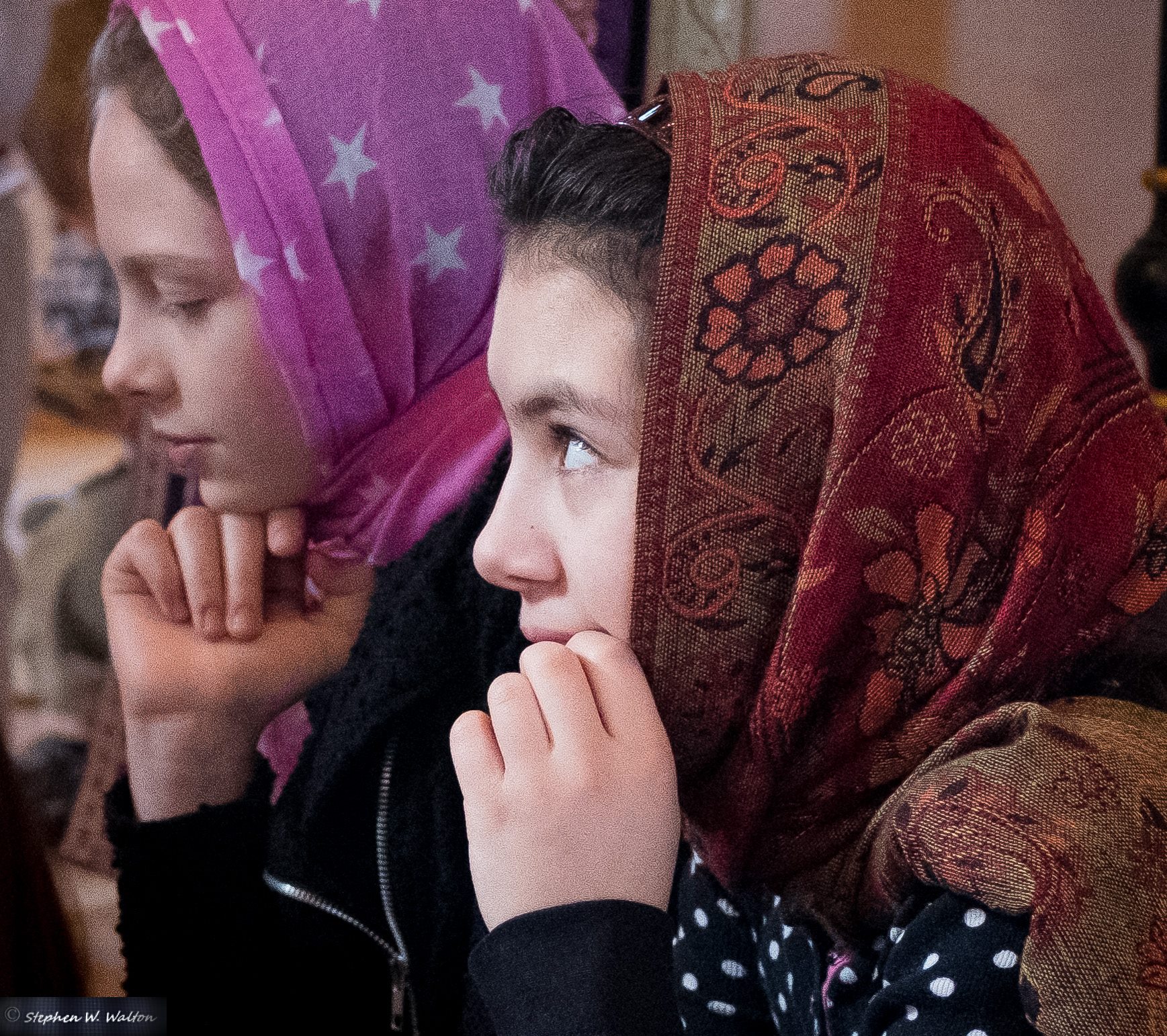  profile of two young girls with headscarves and hands on chin 