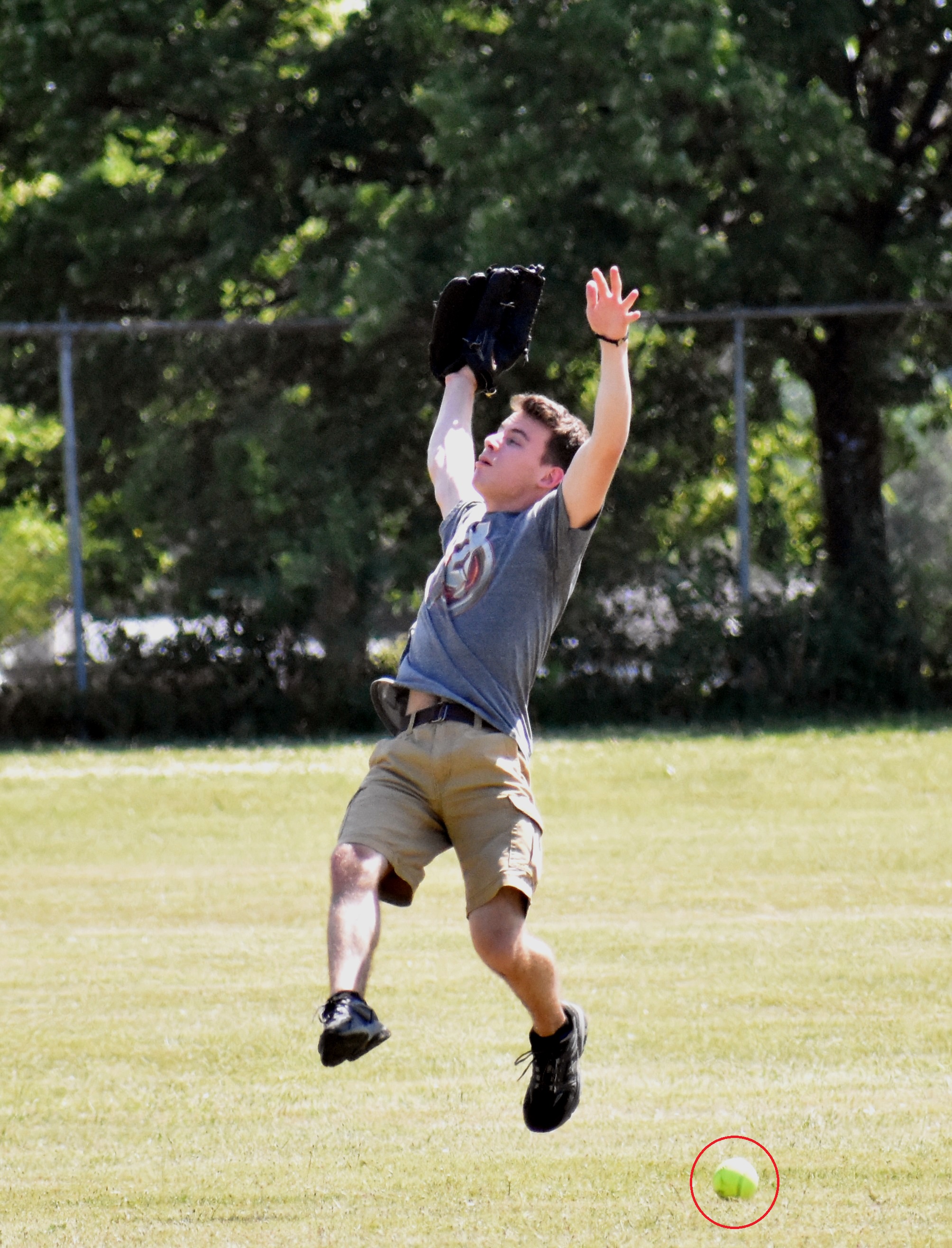  young male player jumping to catch ball 