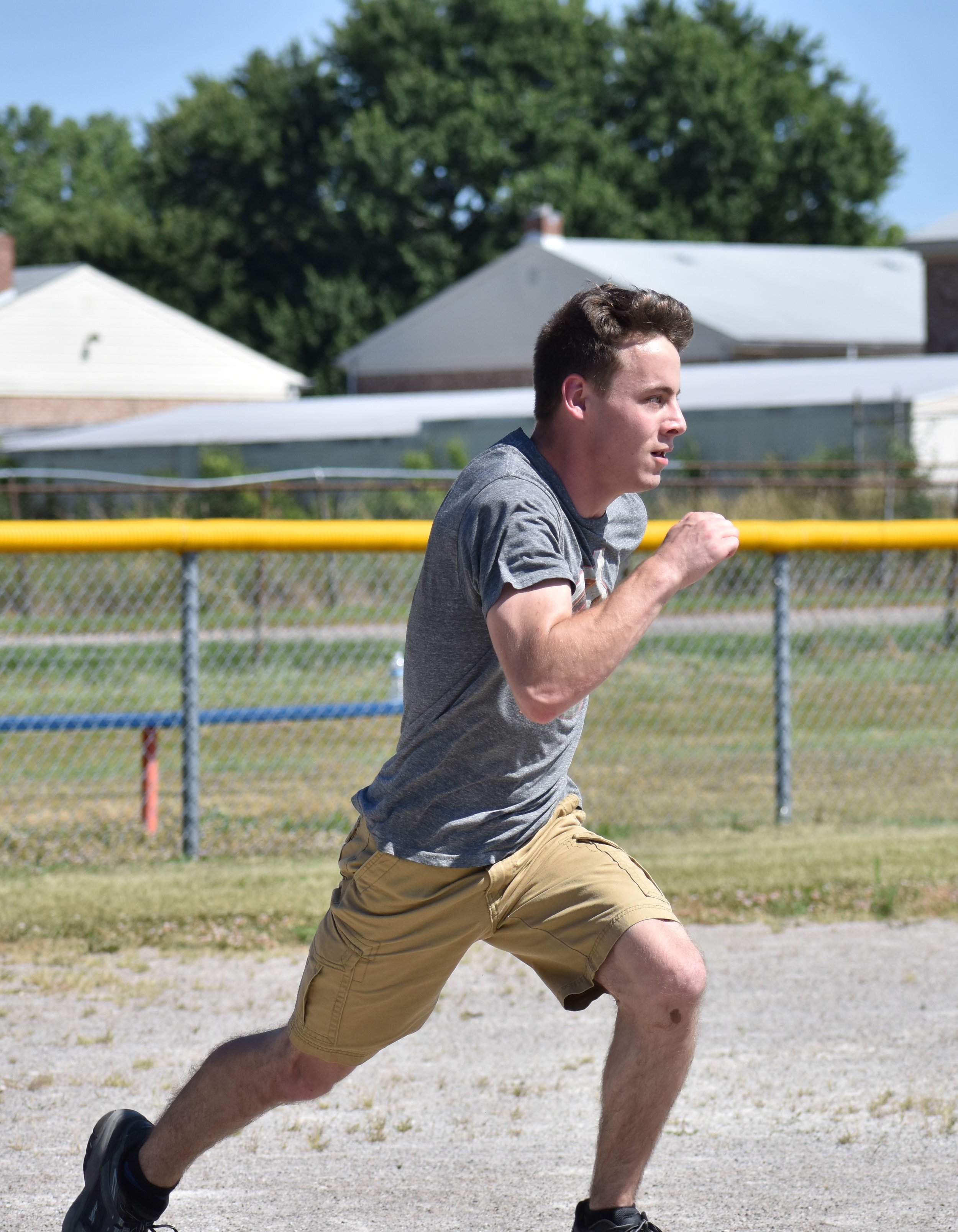 young player running to first base