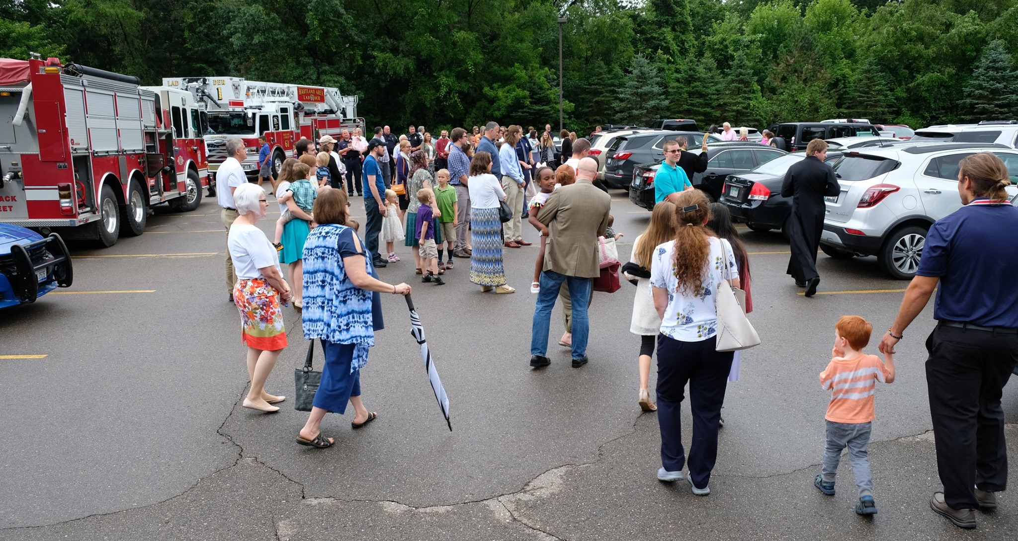  crowd gathered in parking lot for blessing of vehicles 