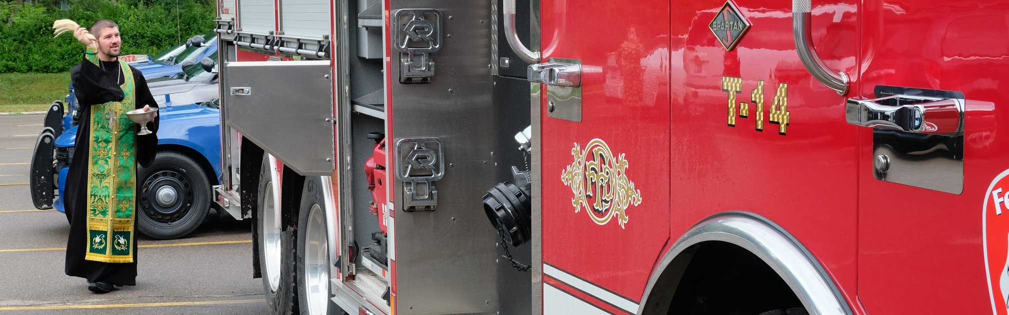 priest blessing fire truck panoramic