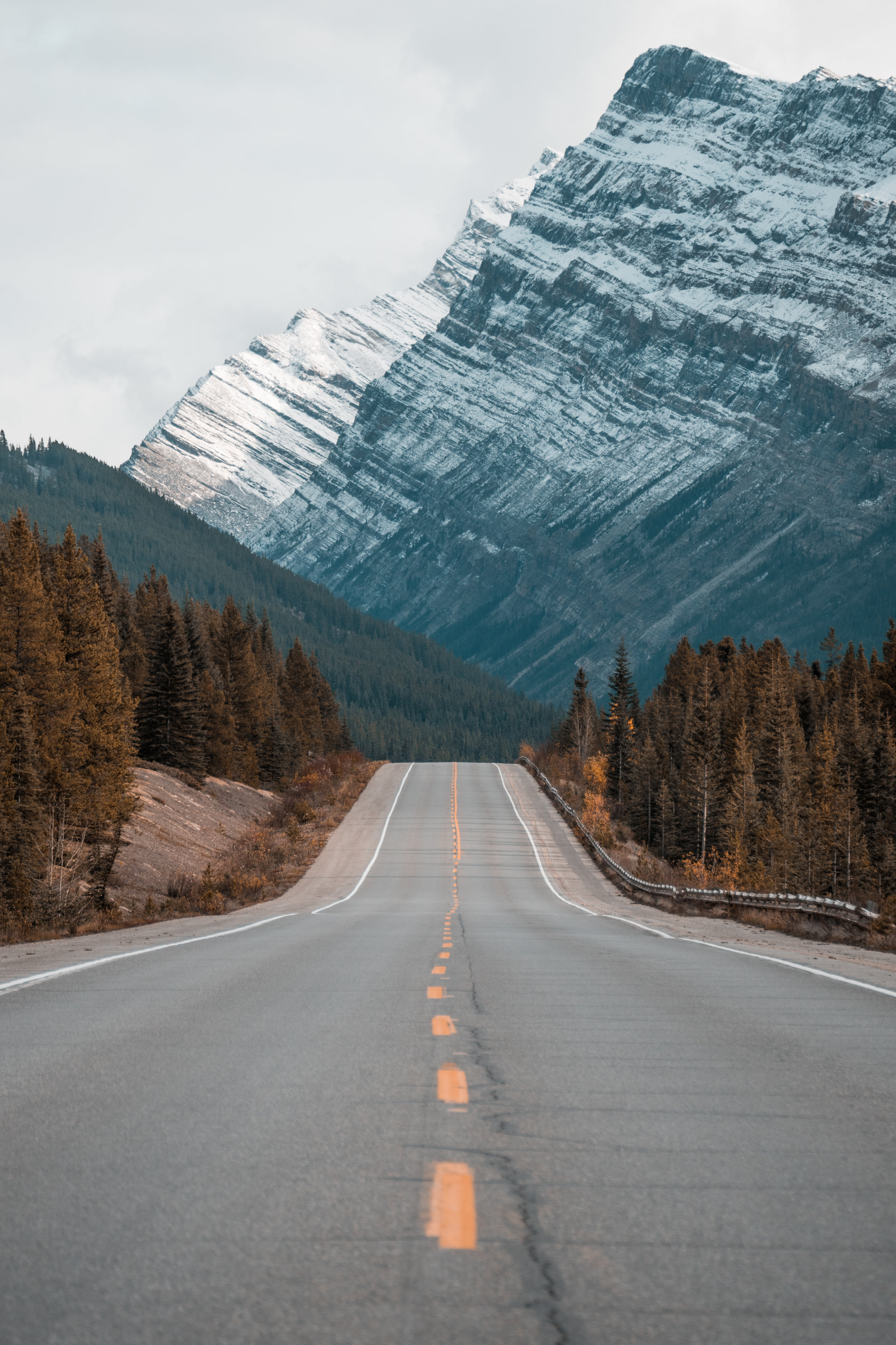 long straight road leading into the foot of a mountain