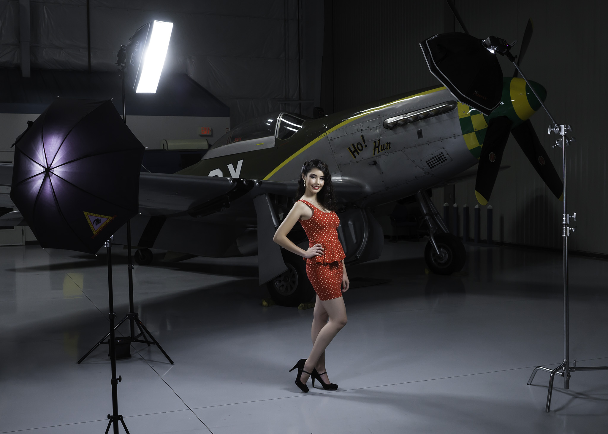 Here, model, Paulina Silva pose with the backdrop of a WWI P-51 Mustang