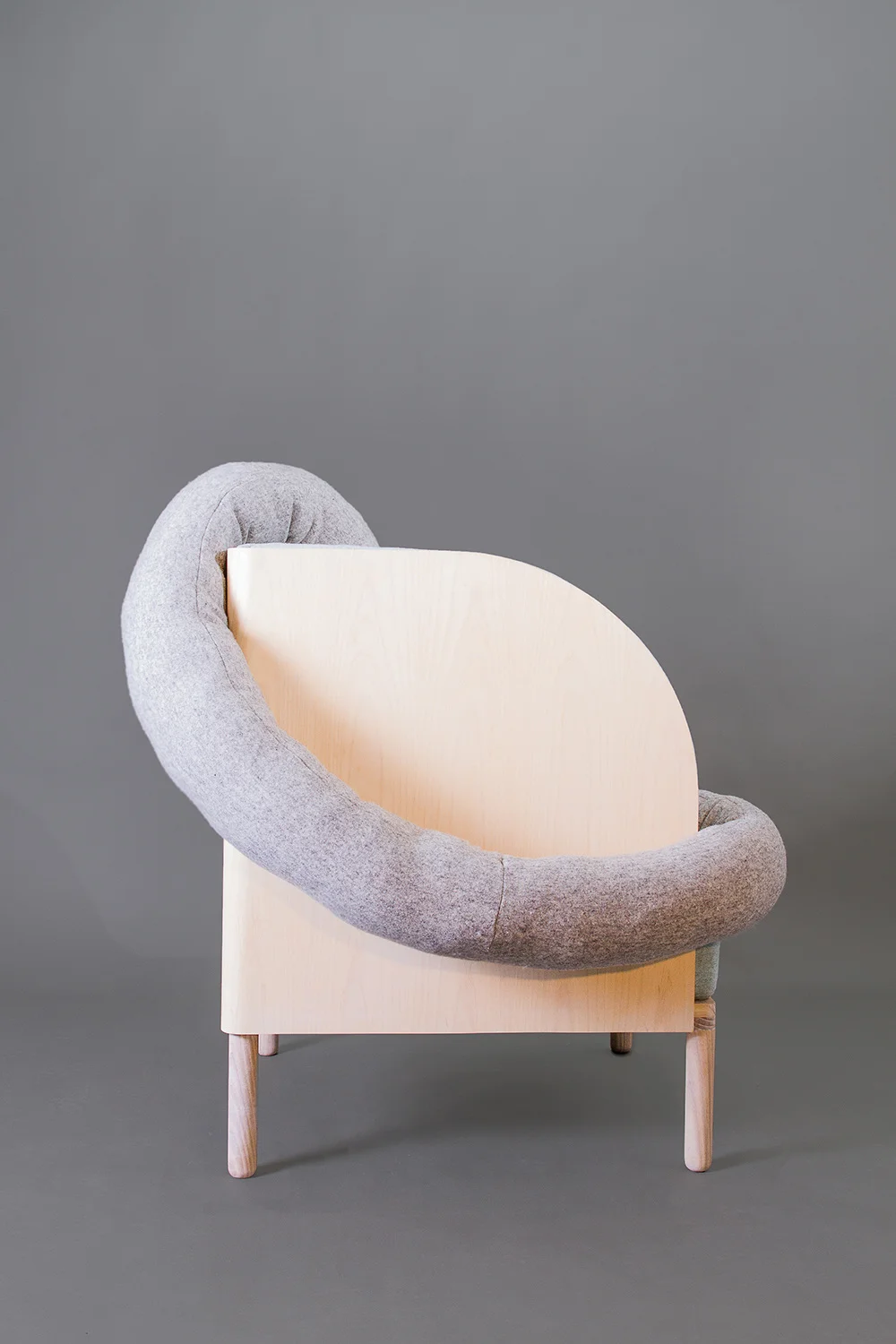 Amanda Ivarsøy Kovacs' chair offers the sitter relaxation and control. The tube shaped pillow serves as a comforting addition.