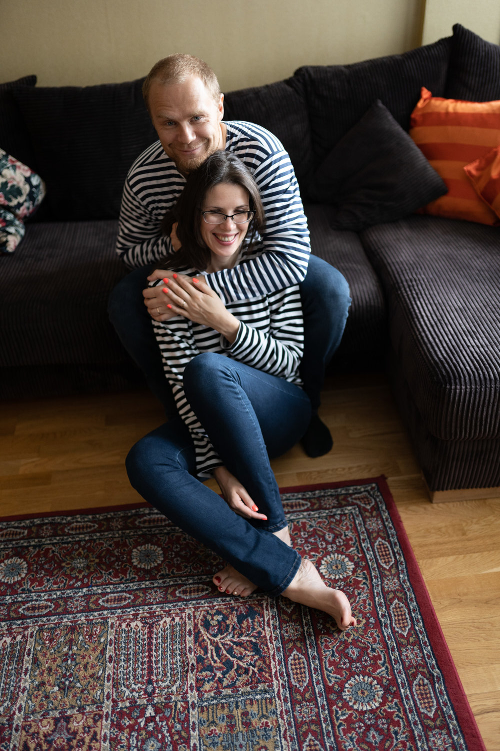 Beautiful couple embrasing at in-home photo session in Kuopio, Finland