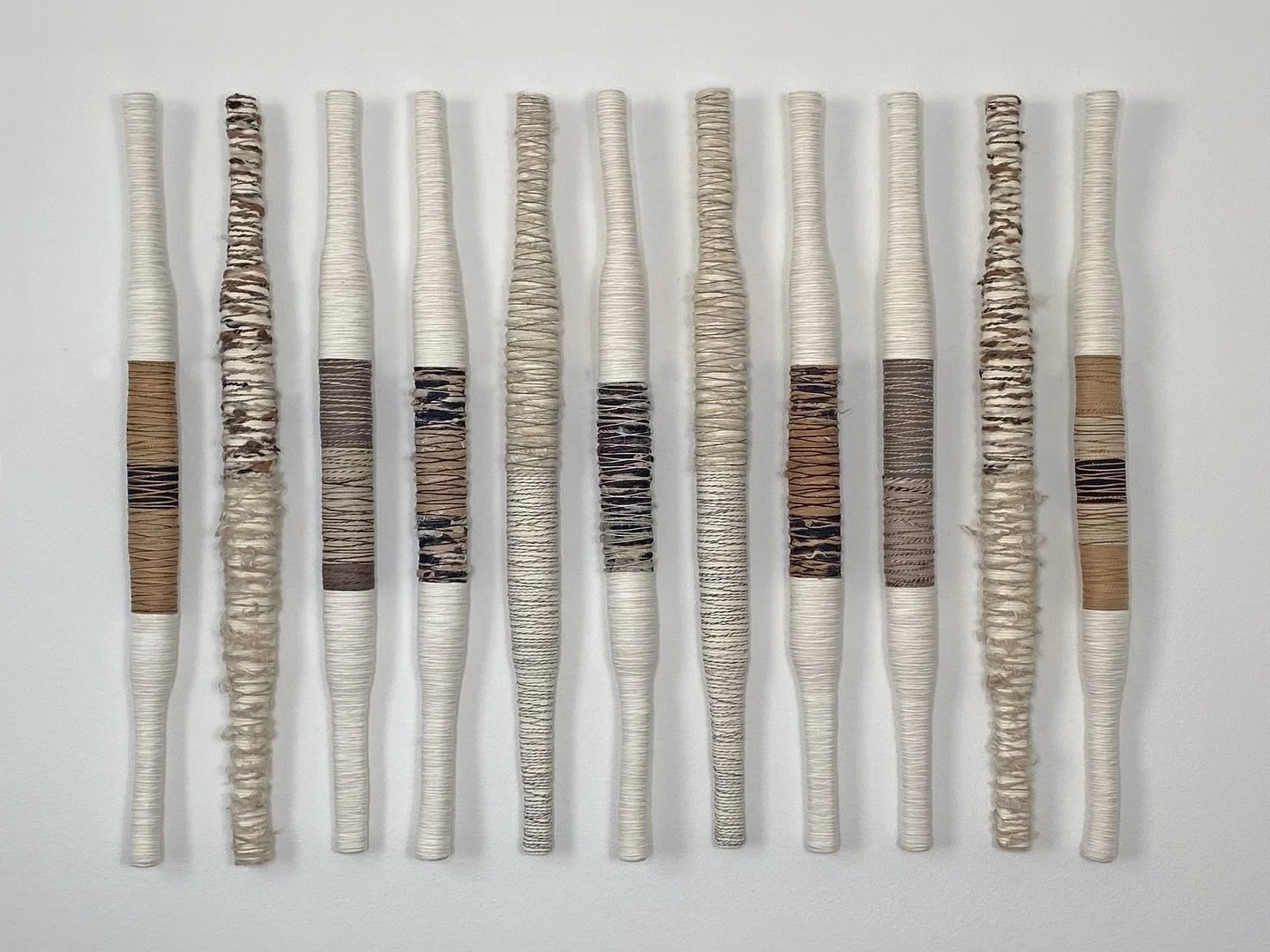 &ldquo;Every thread tells a story.
This piece is created from natural fibers, carefully intertwined and wrapped around wooden structures, exploring textures and neutral tones to create rhythm and harmony.
Inspired by the connection between the organi