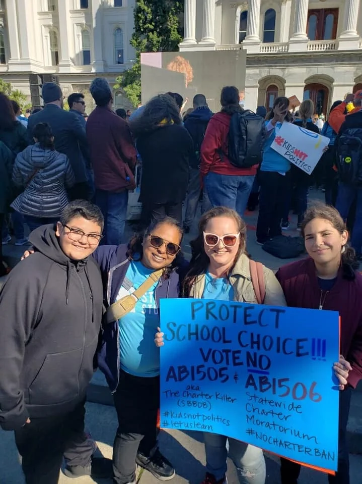 Roxann Nazario (second from right) protesting bills that could shut her daughter’s school down