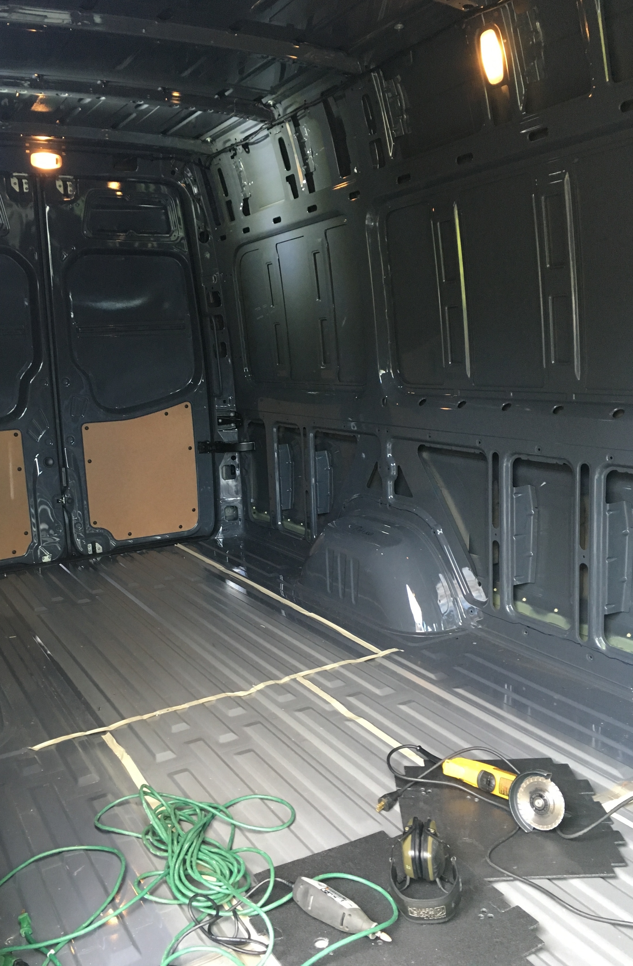 With the factory floor out, we put down some tape lines to check our drawing with reality. The back rectangle is the bed.