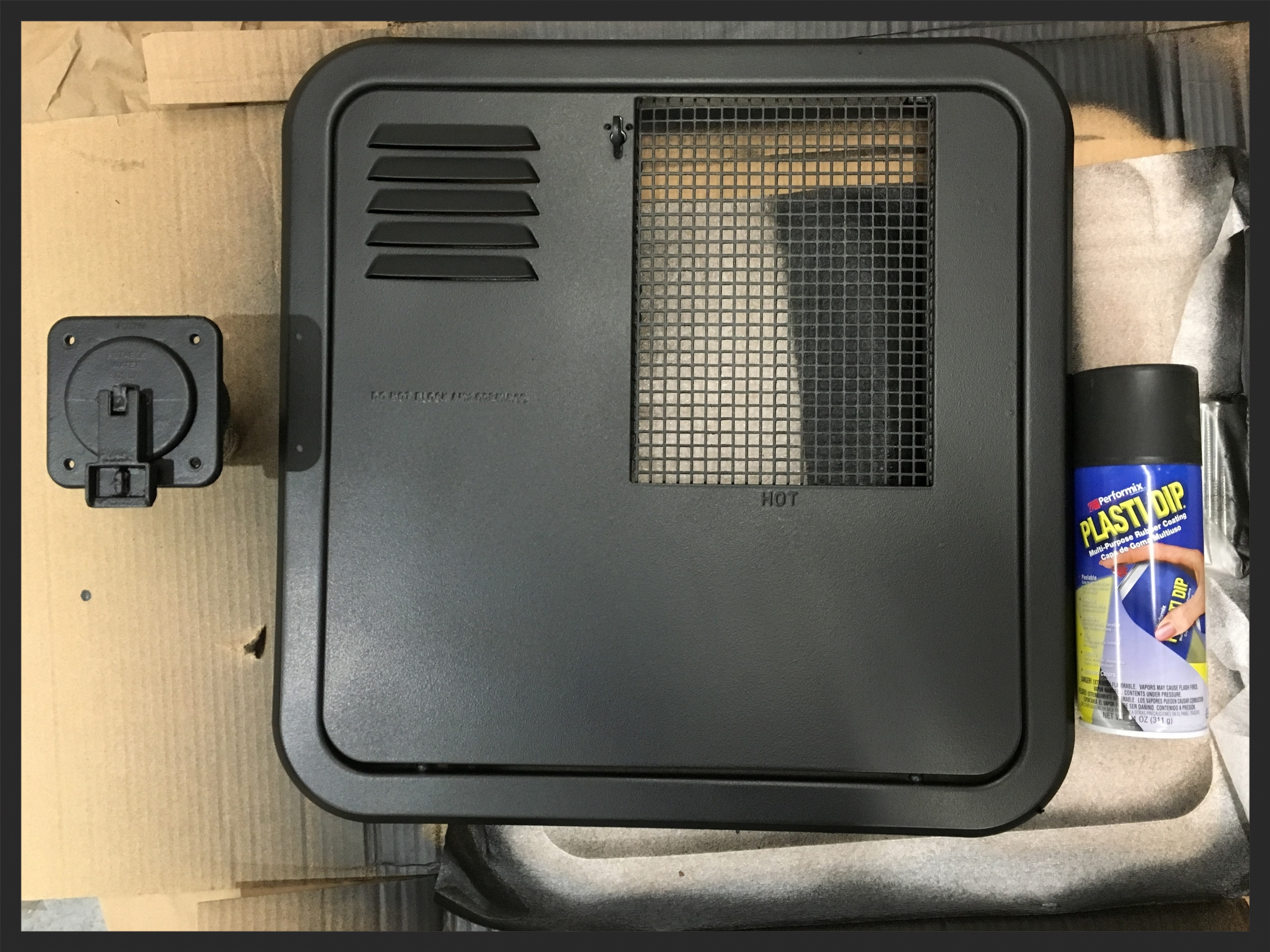 A few coats of rubber sprayed on the water intake and water heater vent door.
