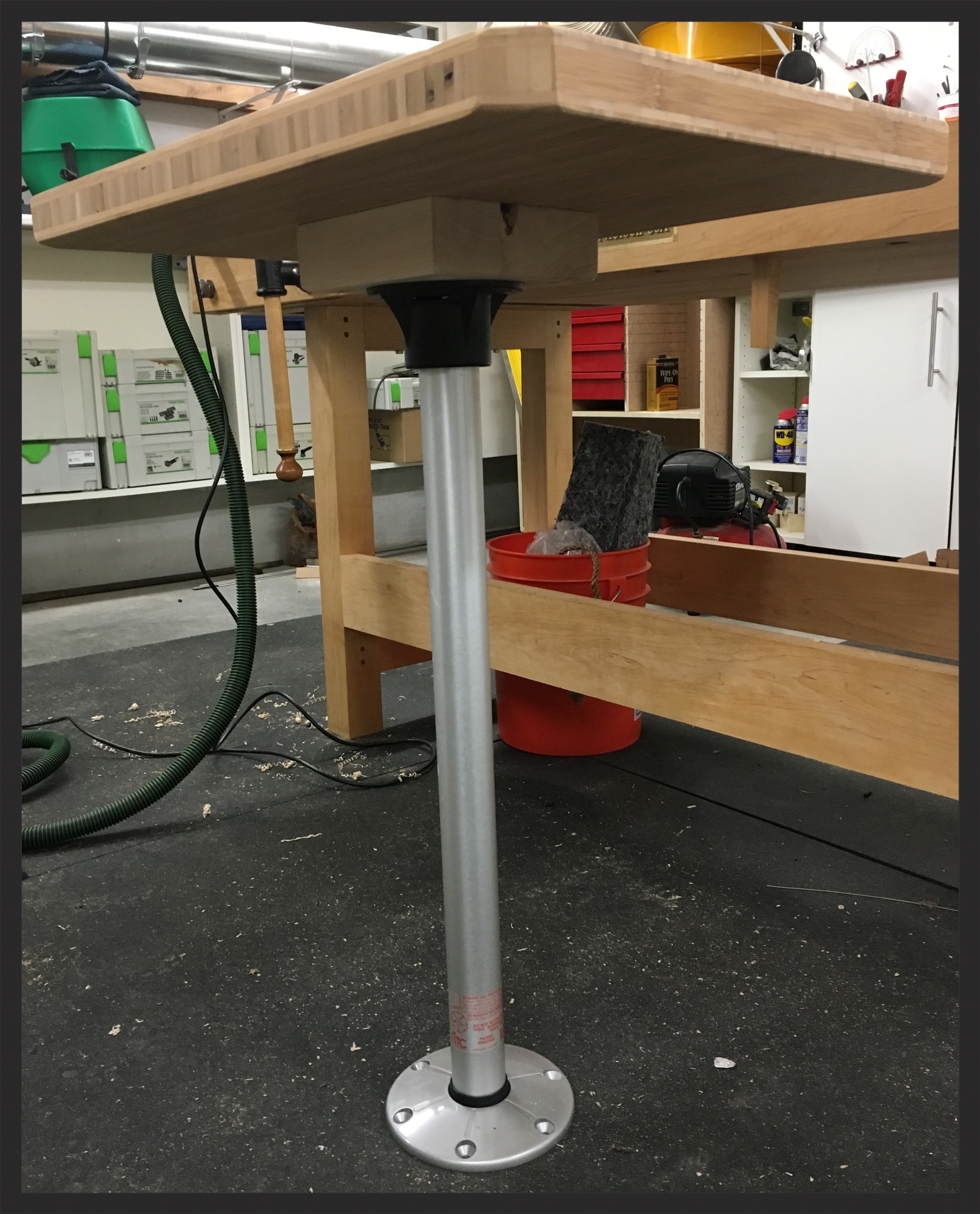 The table sitting on the removable leg. The little block it's sitting on gives us some extra room for our legs. The seats in the sprinter are about 2" too high for comfort.