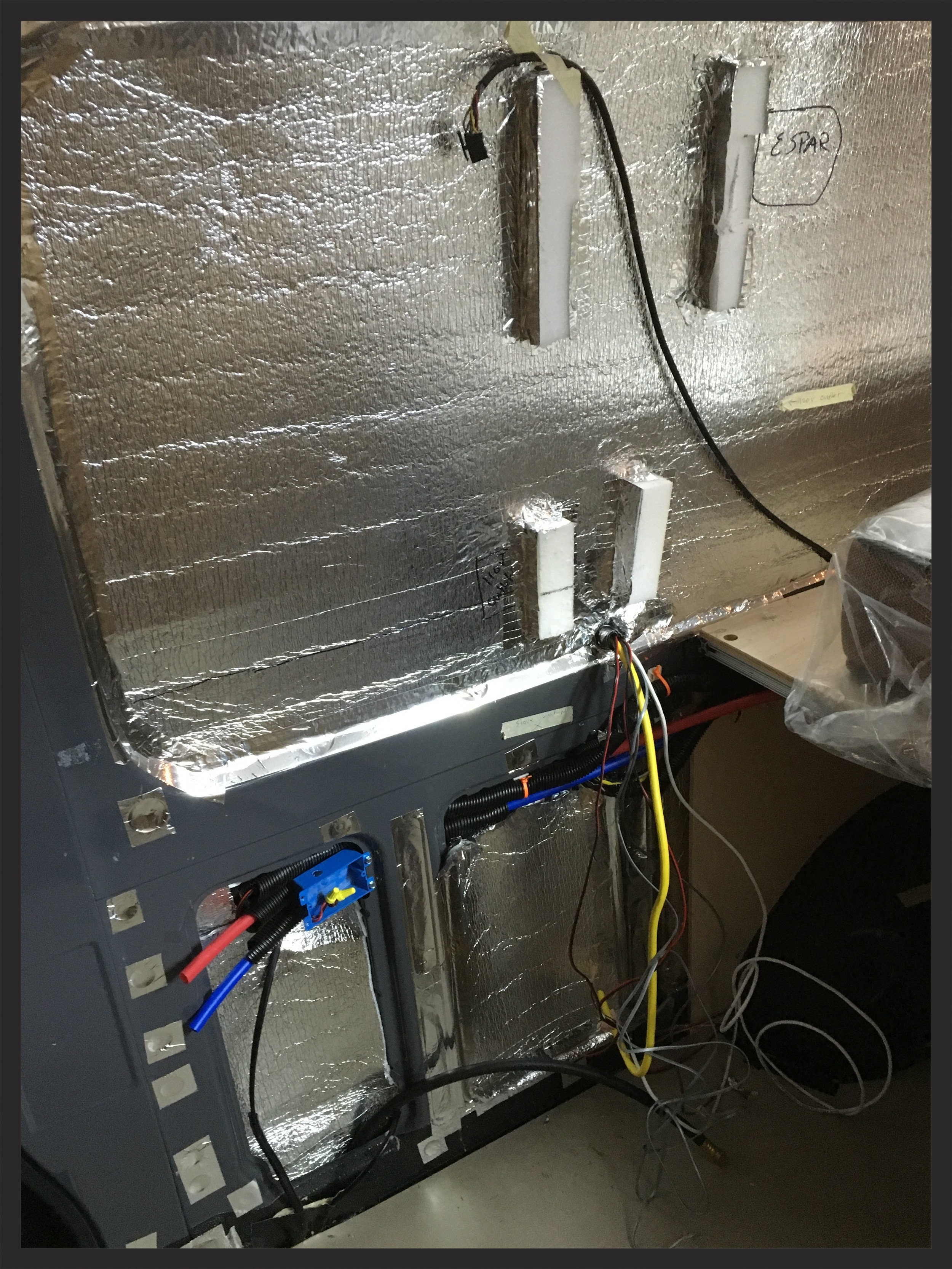 The wall above the galley cabinet has a lot of electrical components that need to get wired in.
