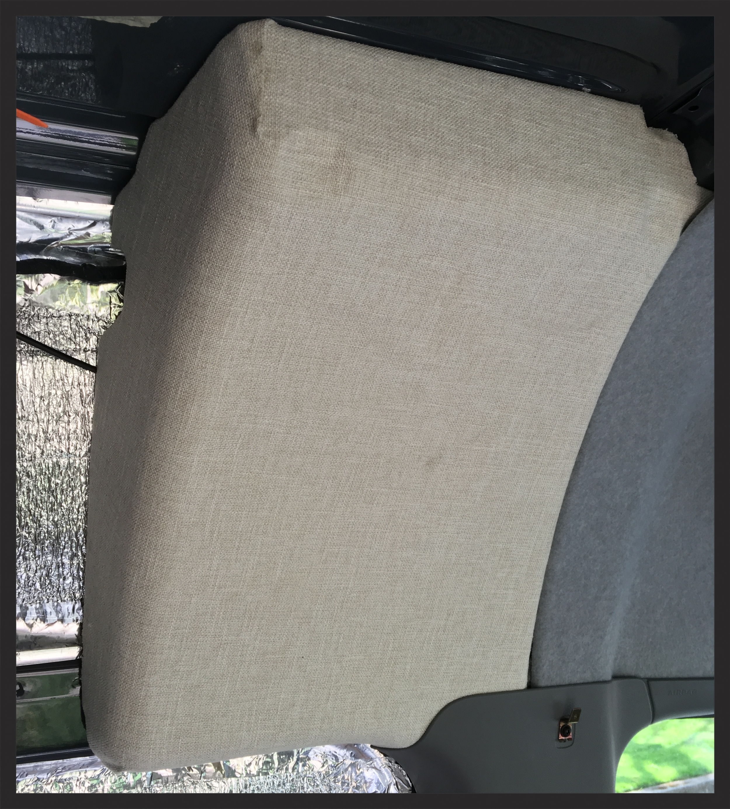 The purpose of these foam blocks is unclear--but they do cover a hole between the headliner in the cab and the cargo area, so we just covered them in cloth