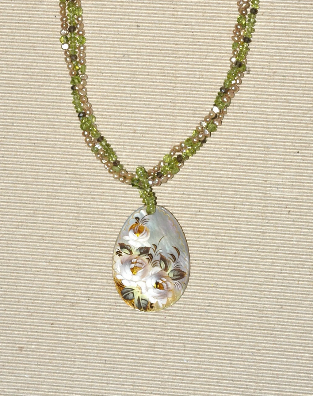3 strand beige pearls, peridot, smoky quartz with painted shell.jpg