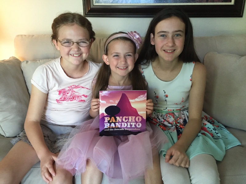 My three legbugs holding the paperback version of Pancho 2.
