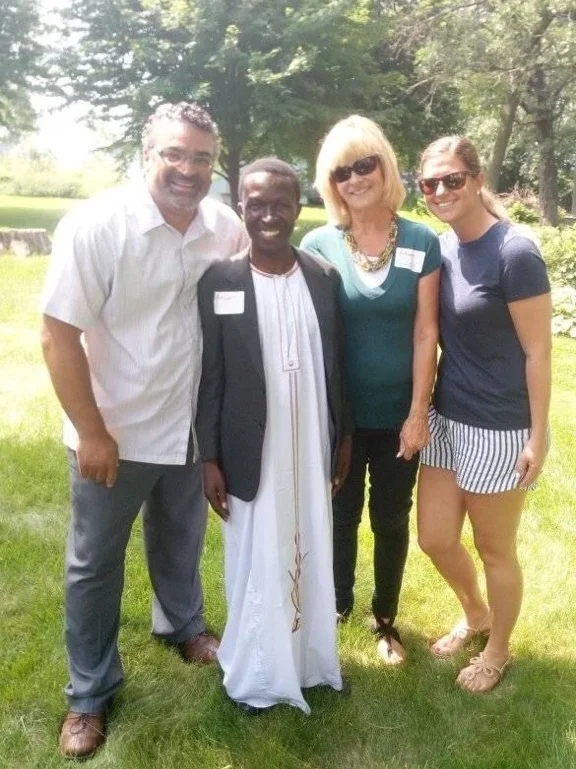 Bruhan pictured with Pastor Paul Dean of Resurrection Lutheran Church (left) and Co-Founder and Board Member of Friends of TASAAGA, Linda Kraemer (second to left).