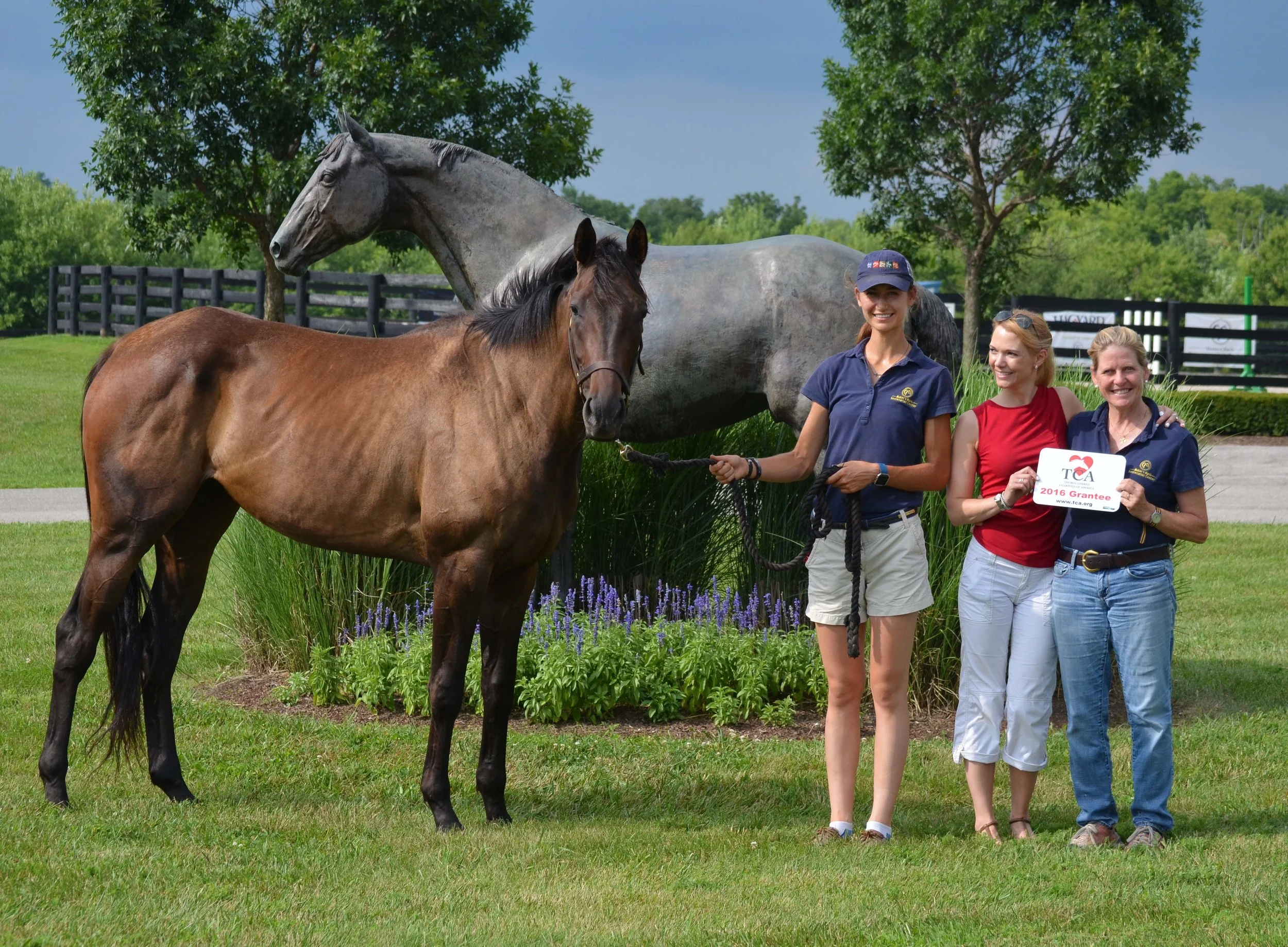 TCA Executive Director Erin Crady (middle) presents the grant award to MMSC Director Susanna Thomas (right) and MMSC Barn Manager/Trainer Erin Strader (left).