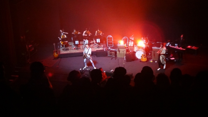 The Last Shadow Puppets - Miles Kane holds down the stage while Alex Turner (bathed in red light) commands the front row.