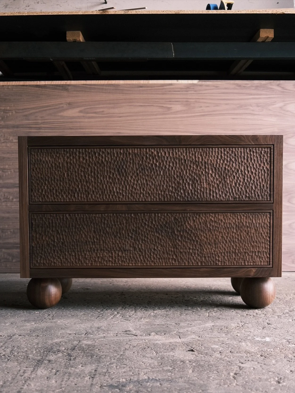 Looking back to this vanity that we made from solid walnut. We meticulously hand carved the drawer fronts and turned the solid walnut feet by hand on the lath.