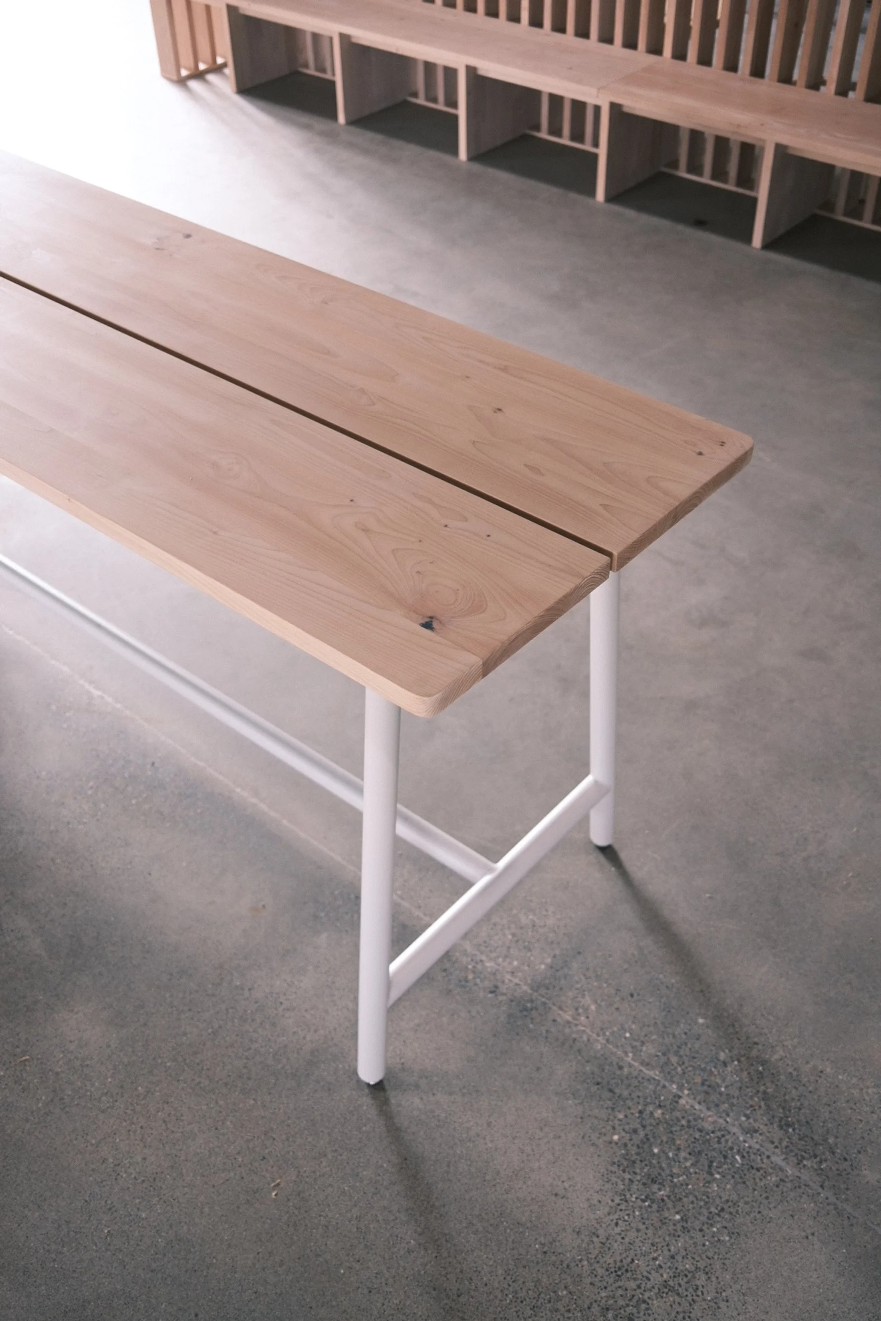 Two-board white oak bench top on a white steel base at Slow and Low, Elk Grove