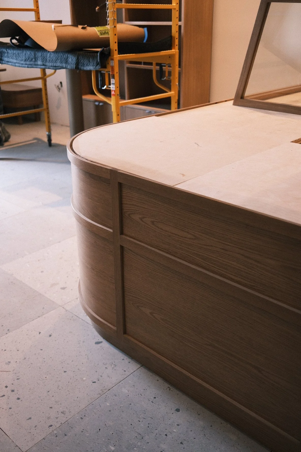 Radiused white oak bar front with applied panel molding during fabrication for Little While, San Diego