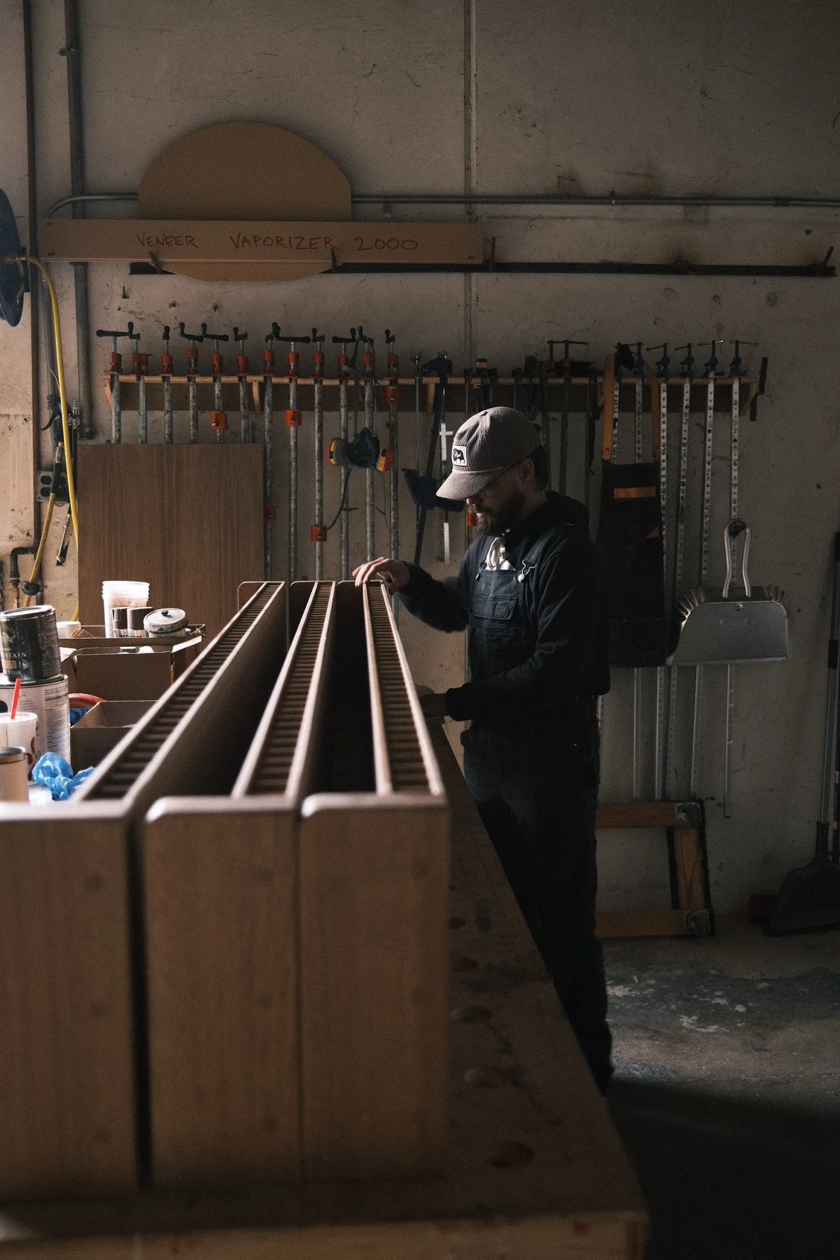 Craftsman assembling slatted white oak shelf rails in the PhillBuilt shop for Little While